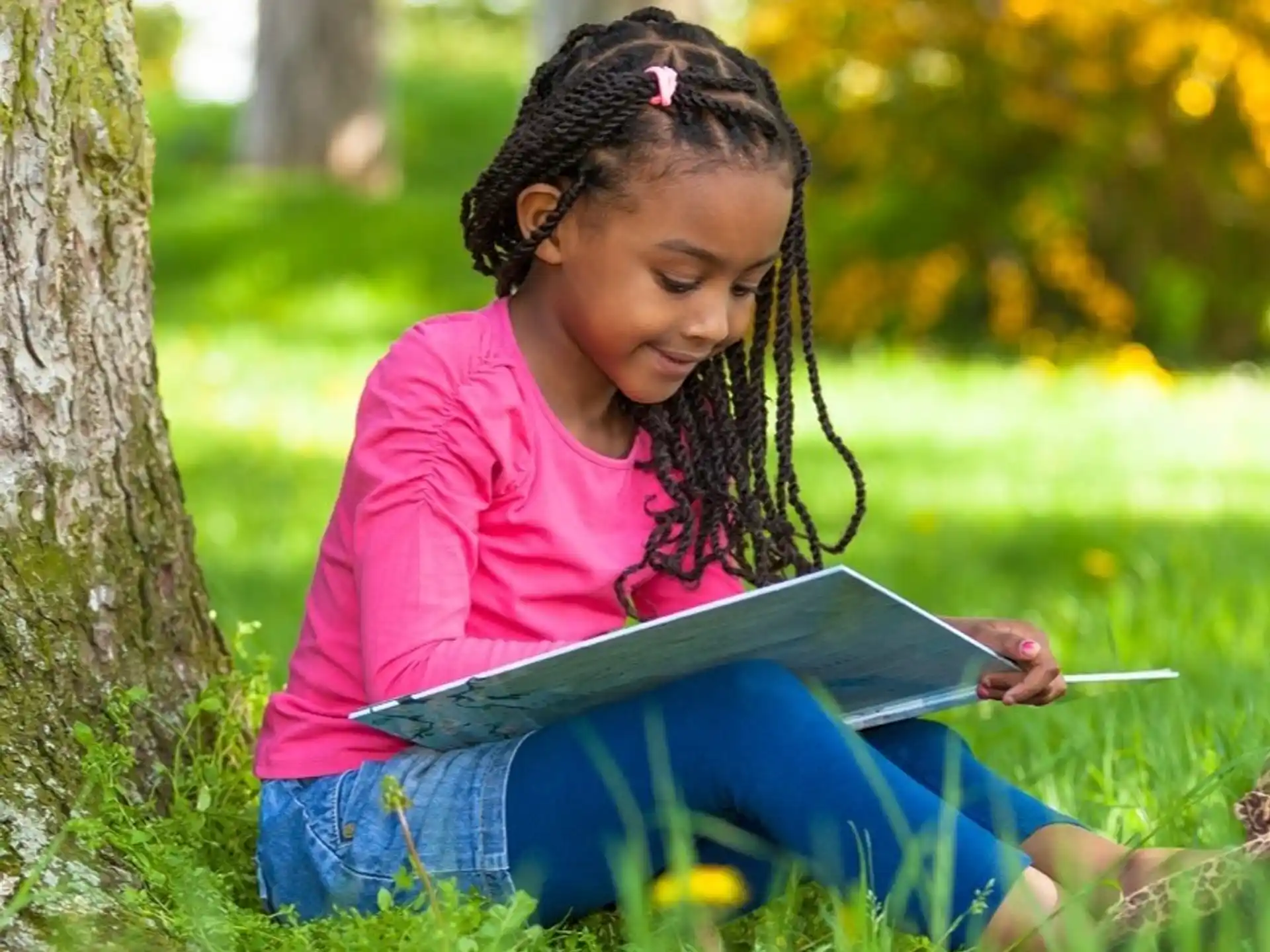 a young girl reading a book