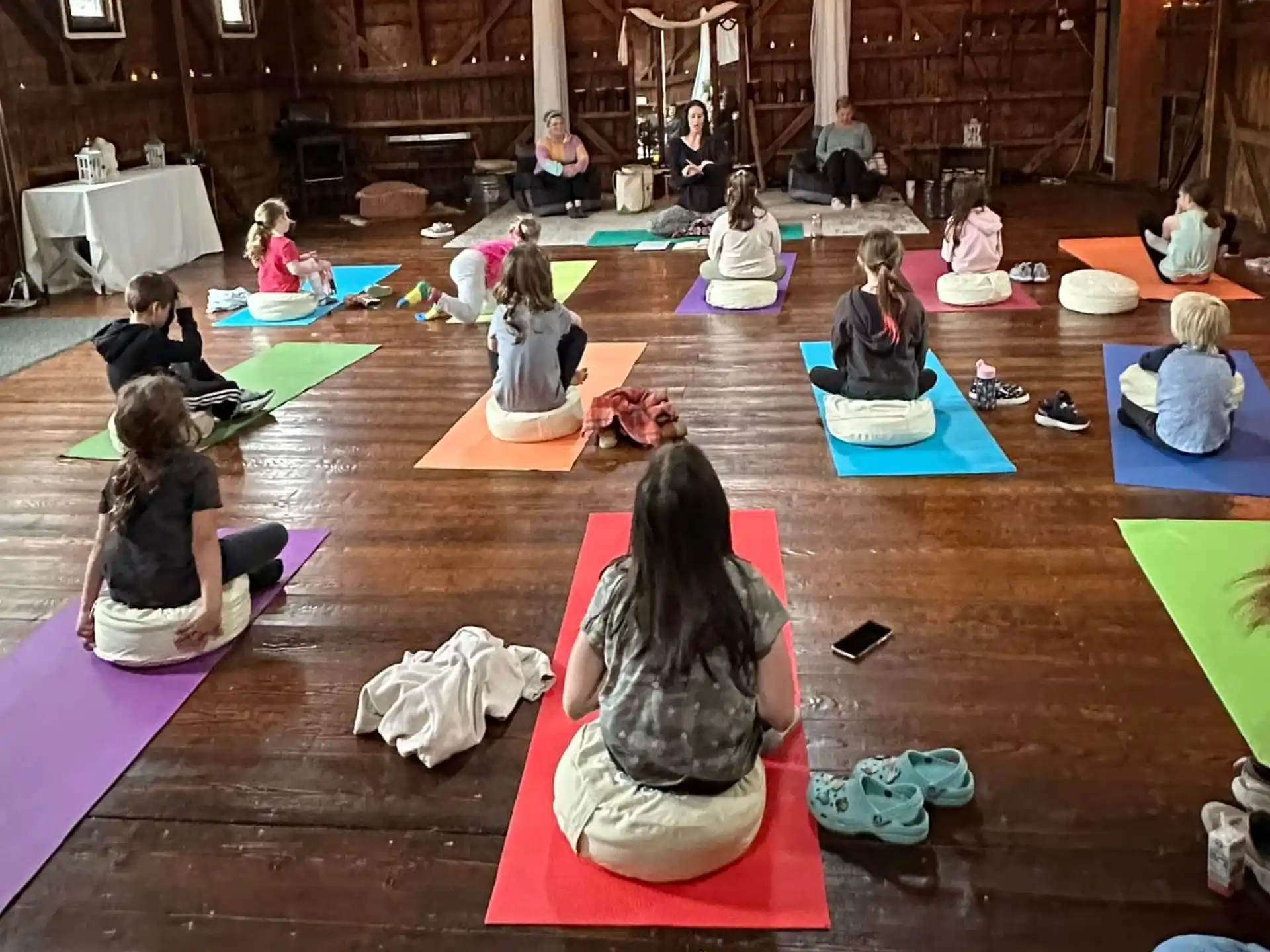 a group of people sitting on mats