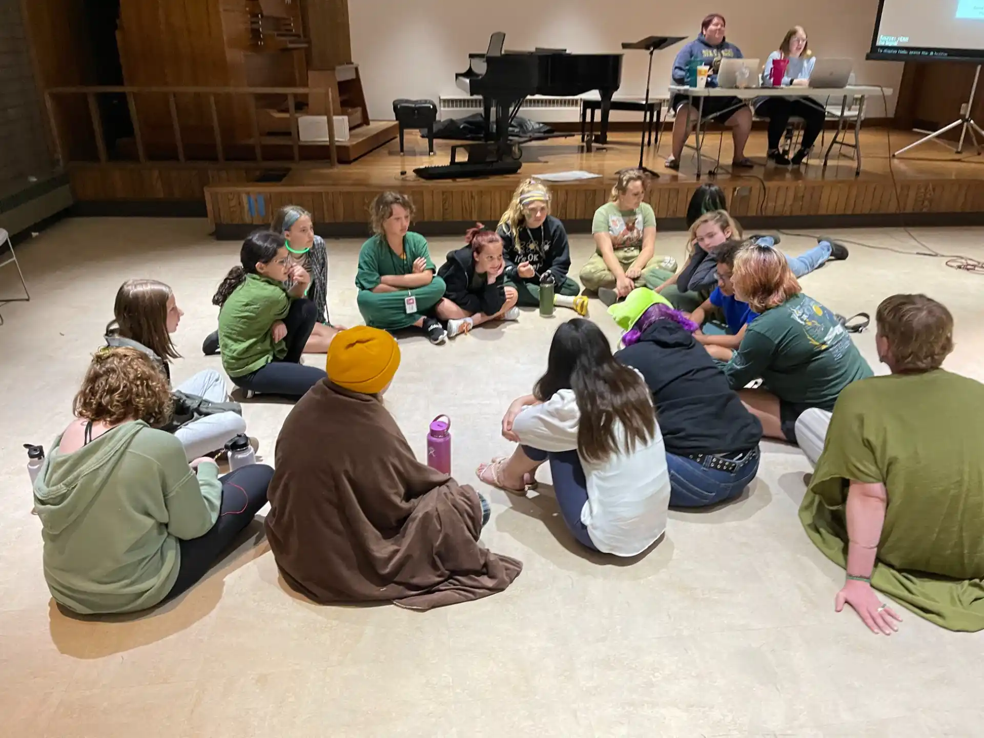 a group of people sitting on the floor