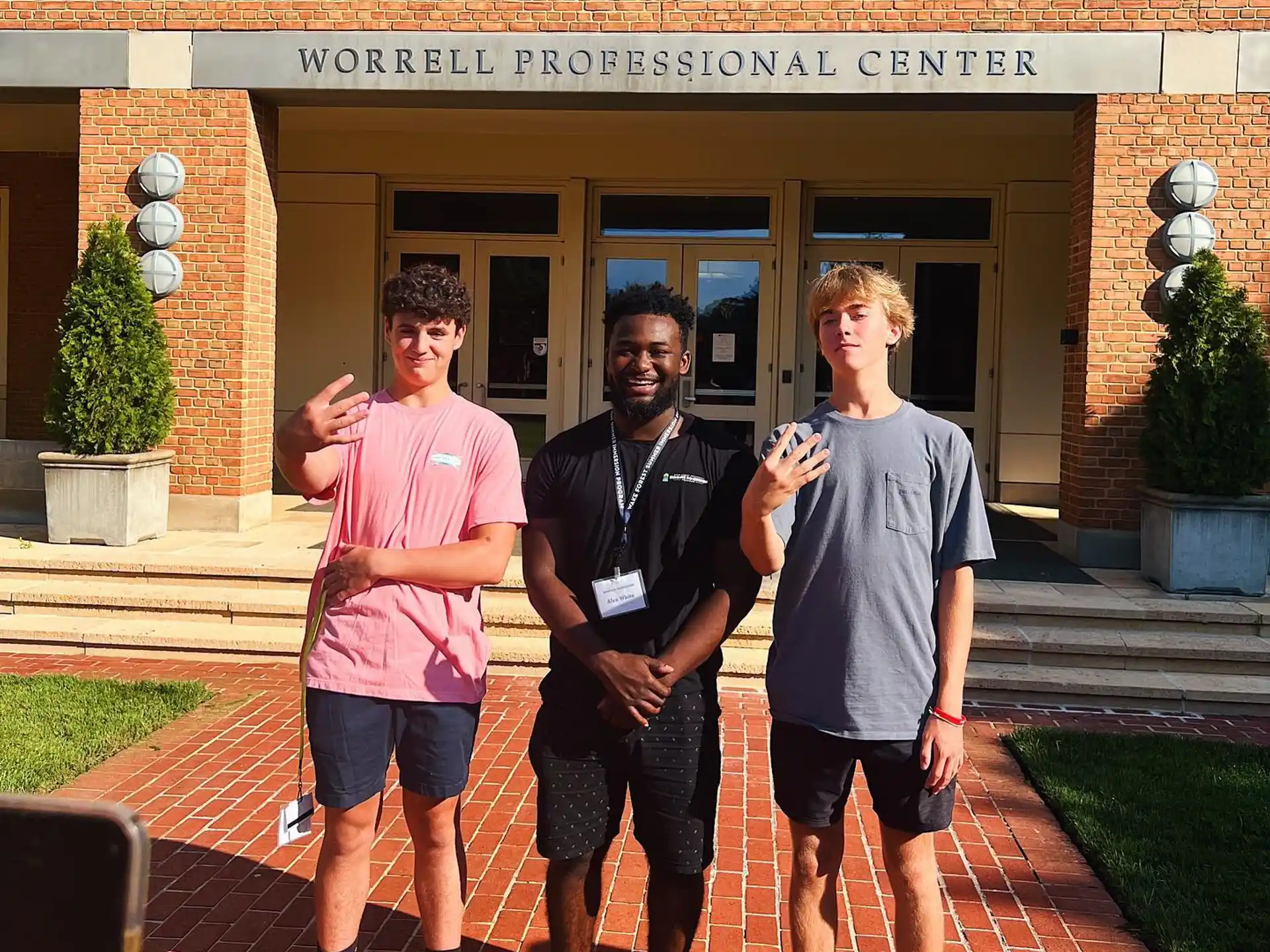 a group of men posing for a photo in front of a building