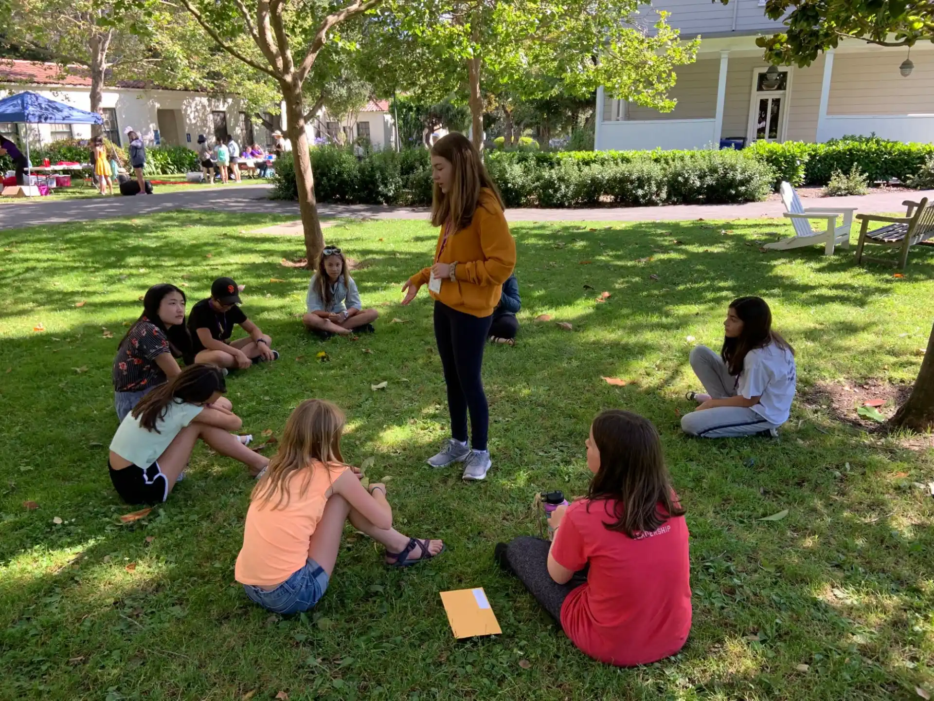 a group of people sitting on the grass