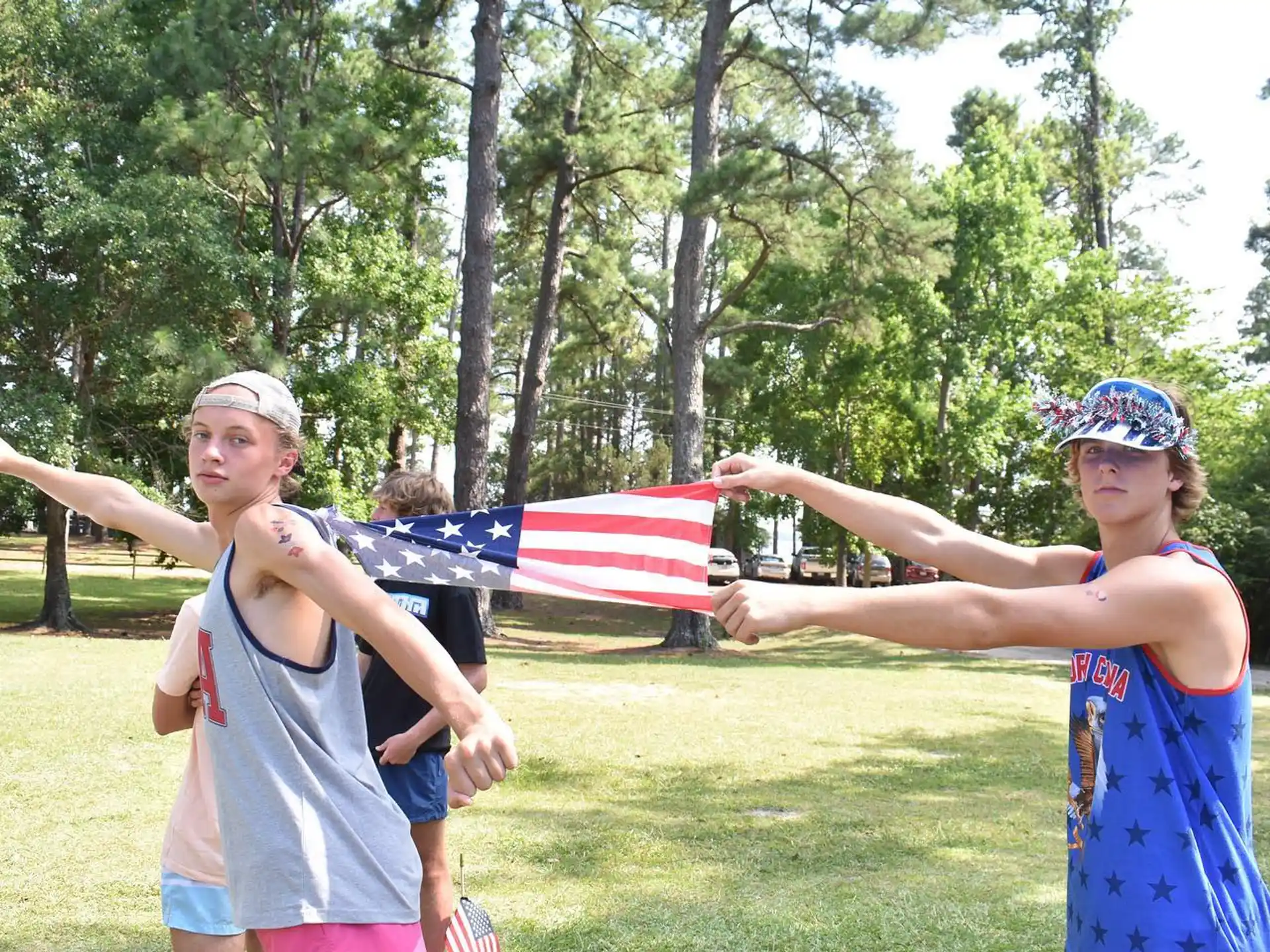 a group of women running in a park with a flag