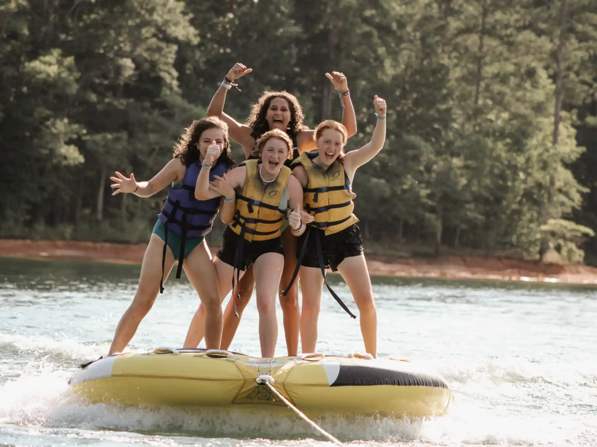 a group of women on a paddle board