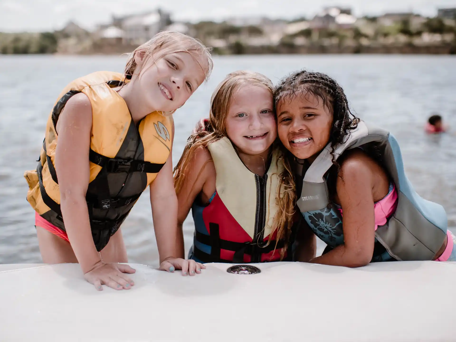 a group of women in life jackets on a boat