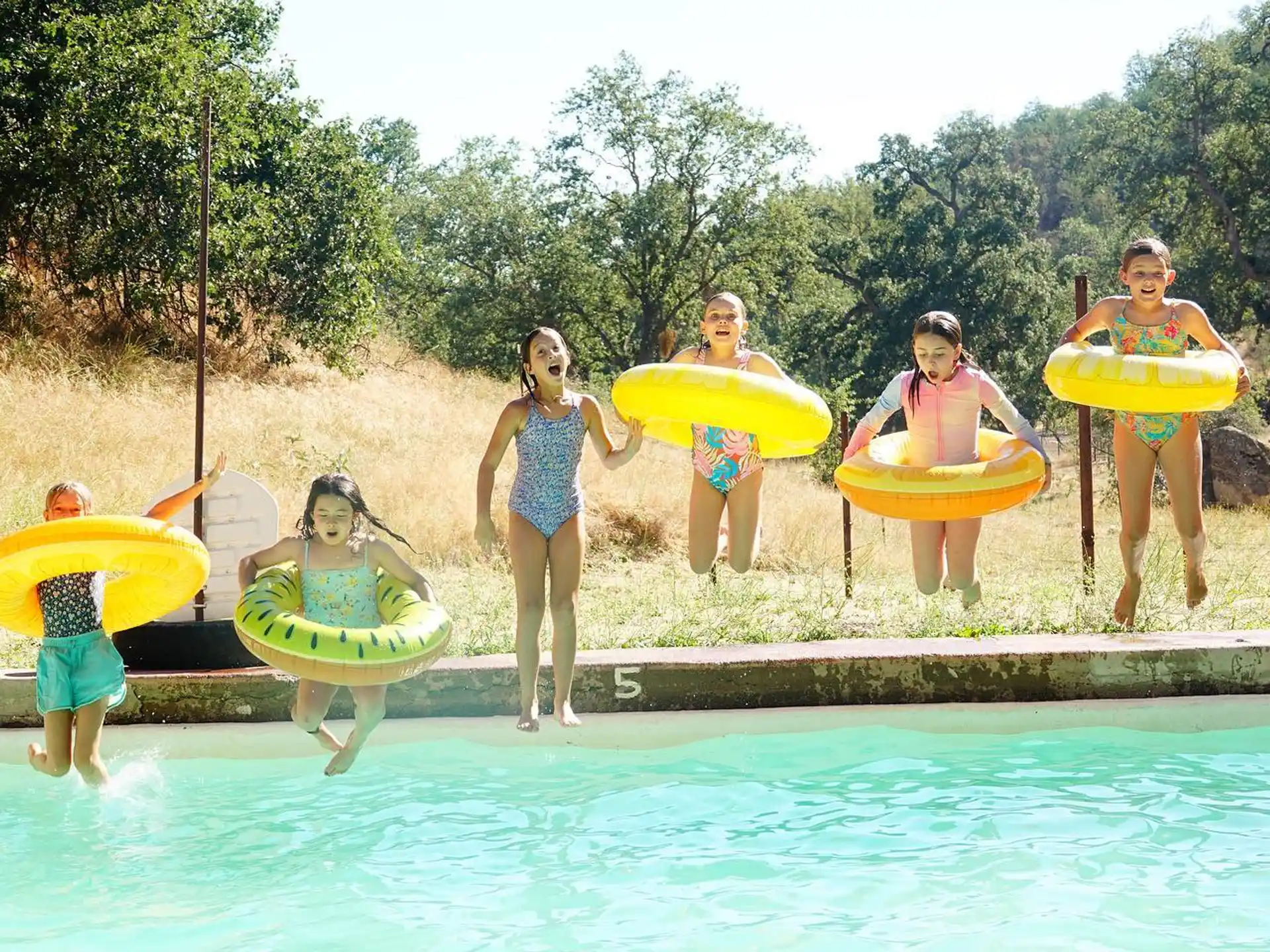 a group of people holding surfboards