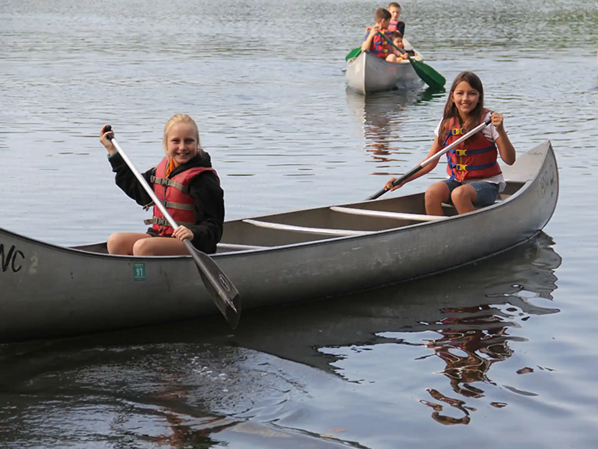 a couple of girls in a canoe