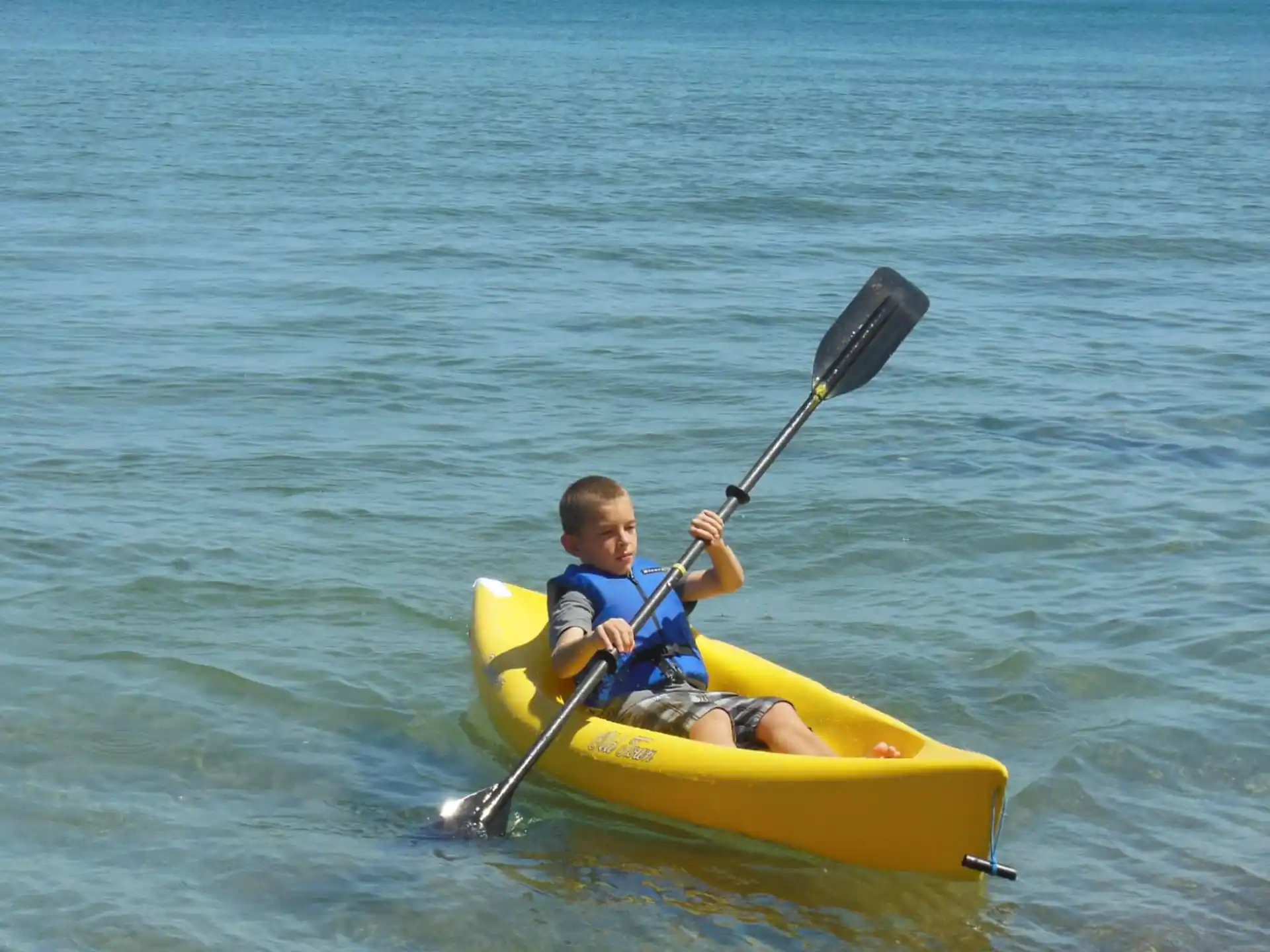a boy in a yellow kayak