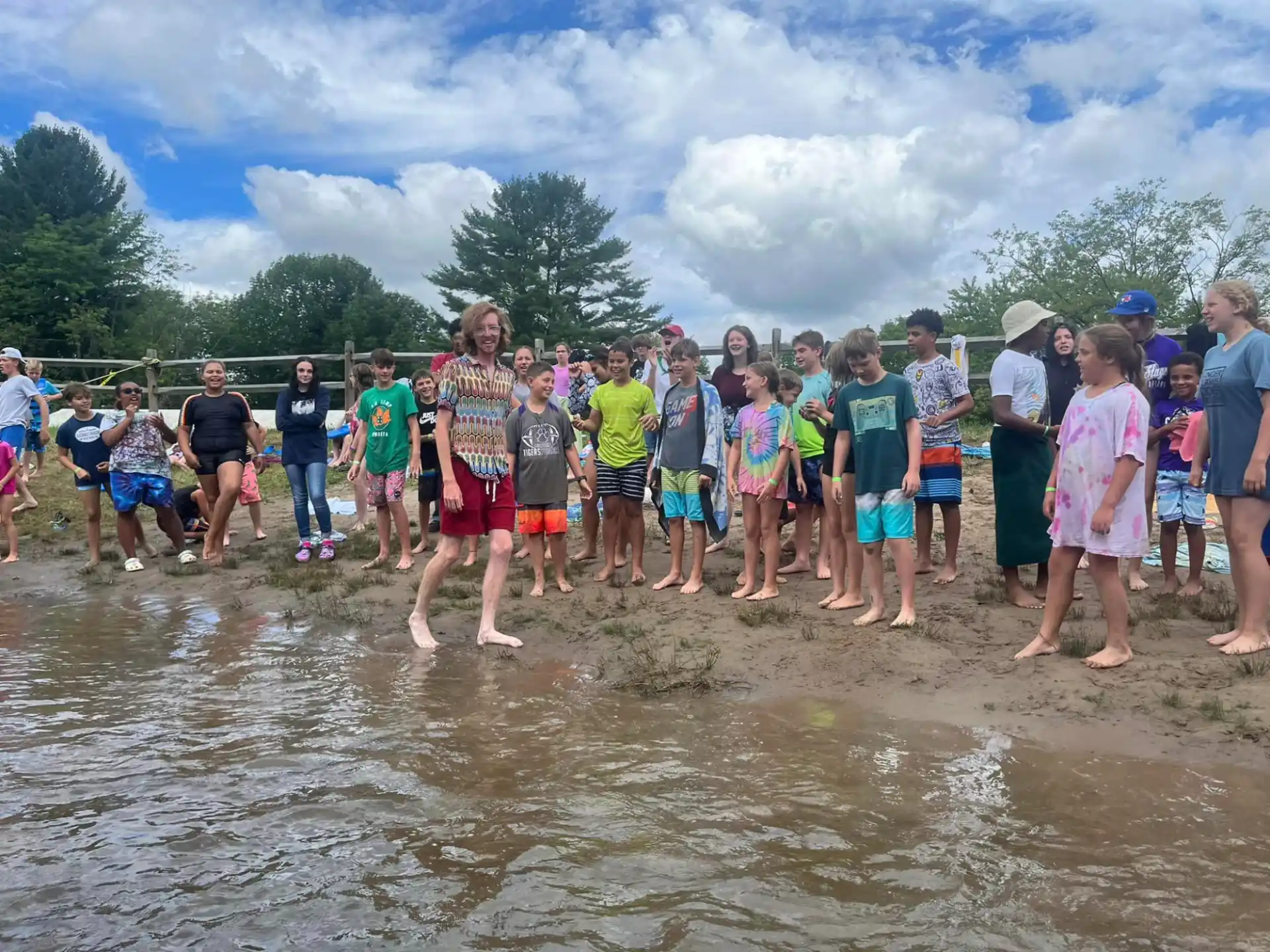 a group of people standing in a muddy area