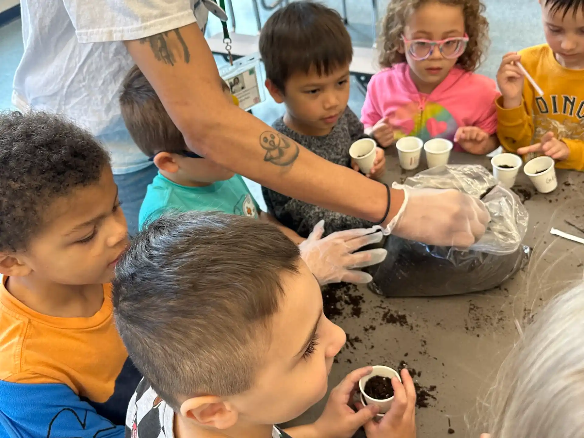 a group of children sitting around a table