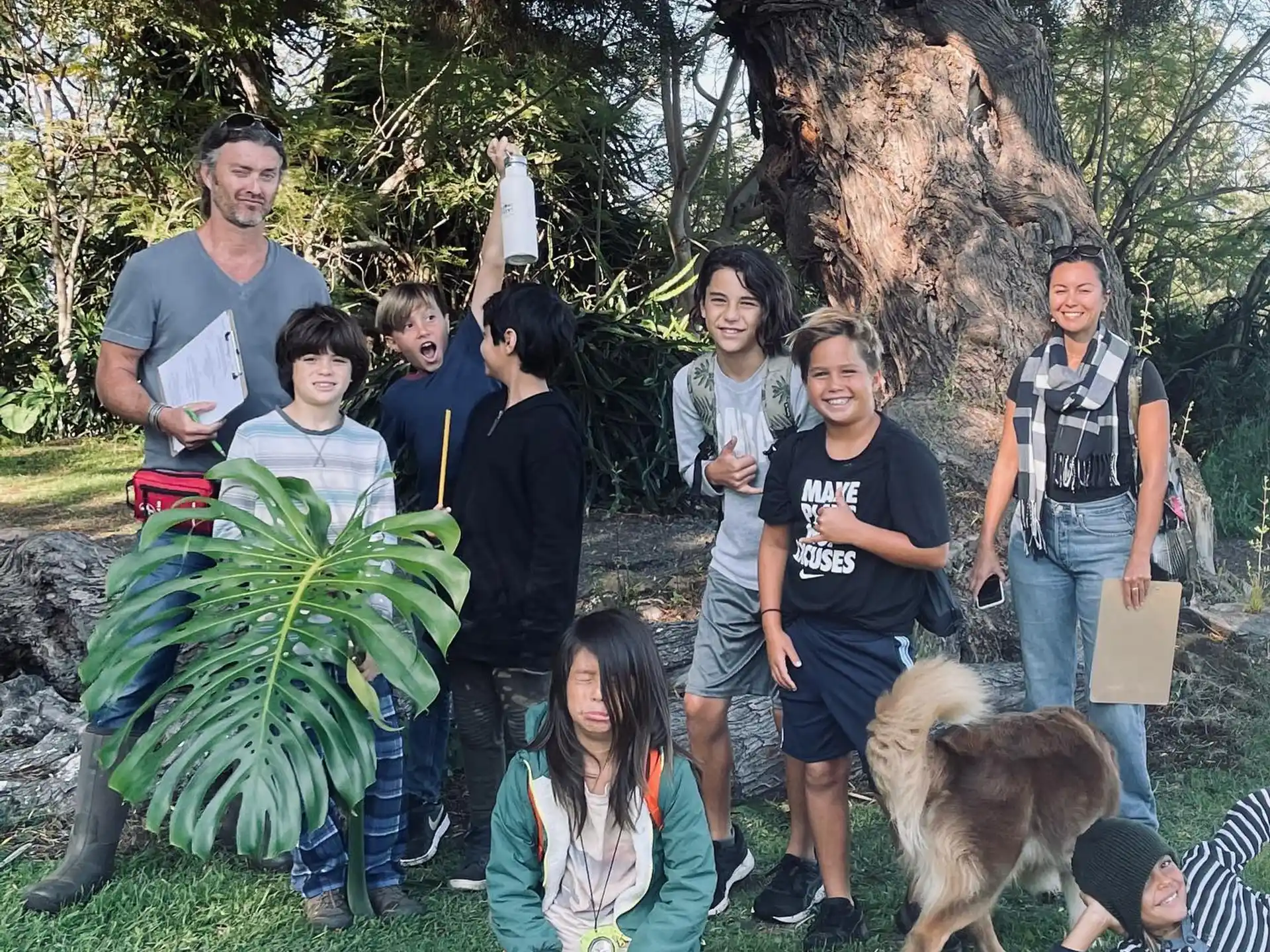 a group of people posing for a photo with a dog