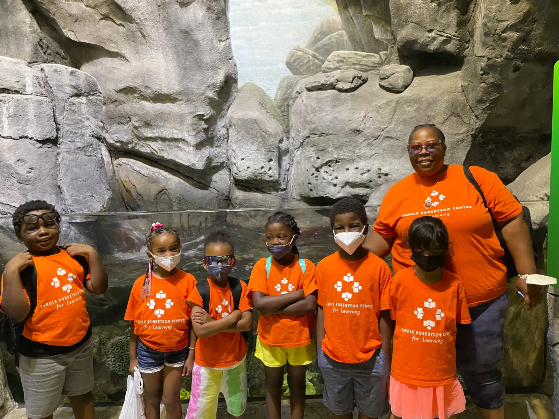a group of people wearing orange shirts