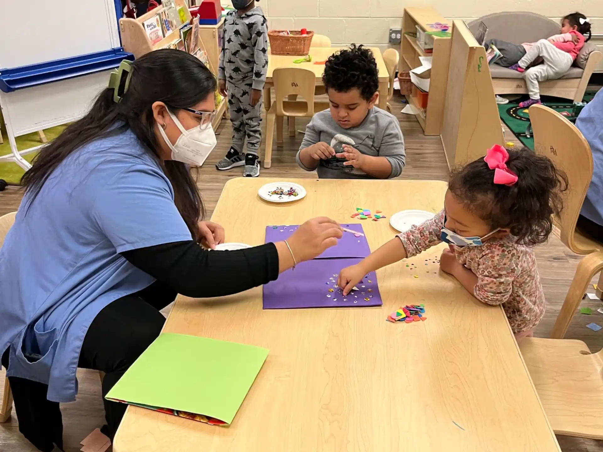 a person and children in a classroom