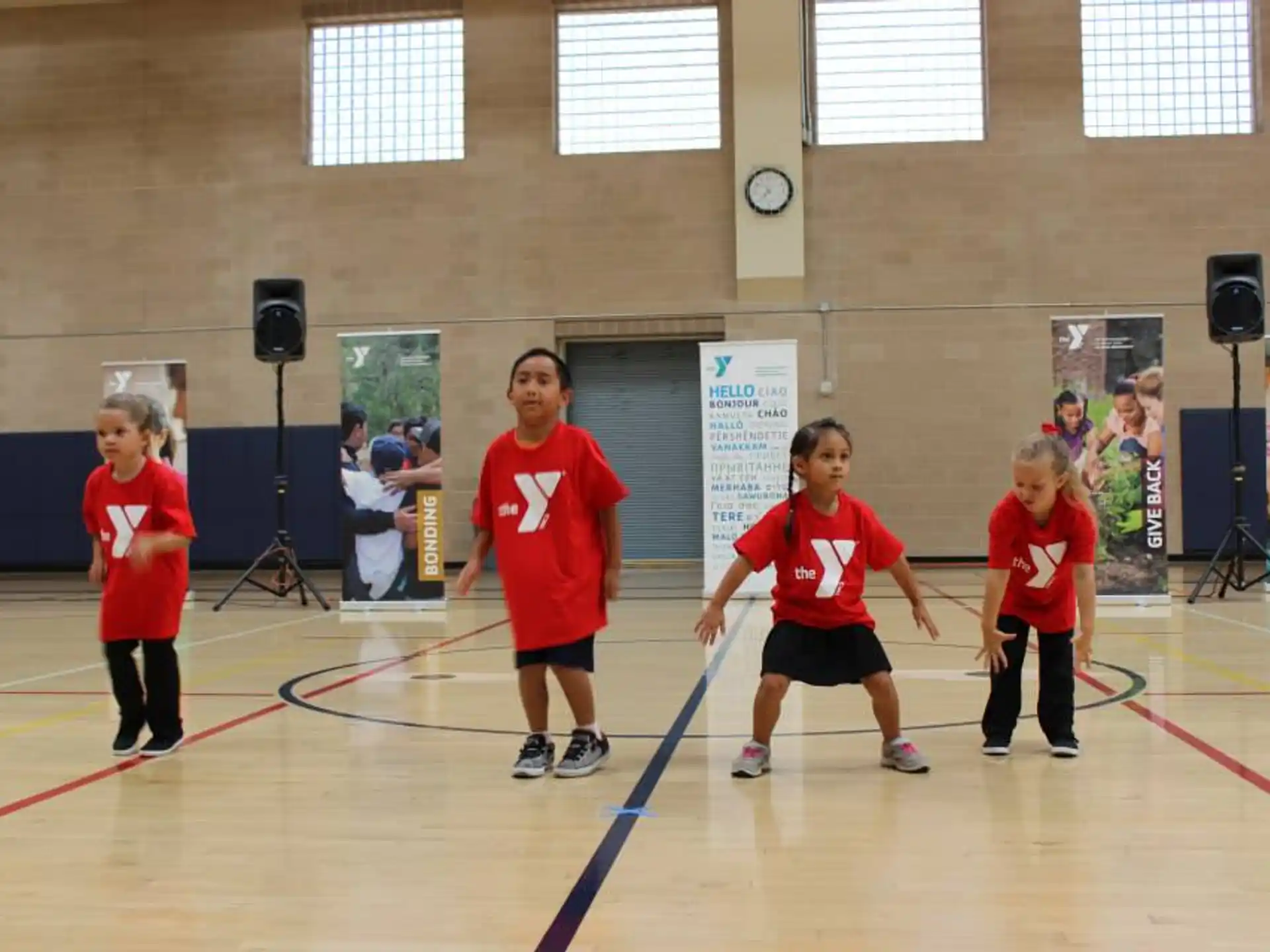 a group of kids in red shirts
