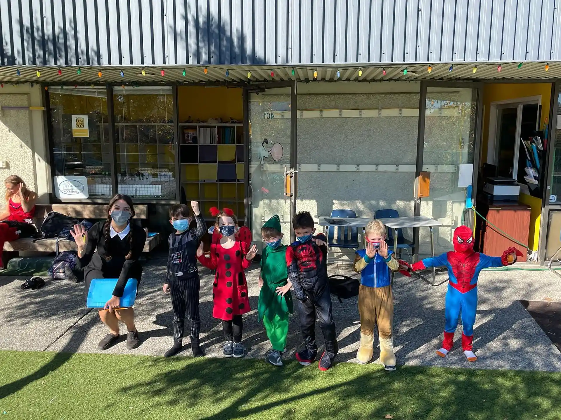 a group of children in clothing outside a building