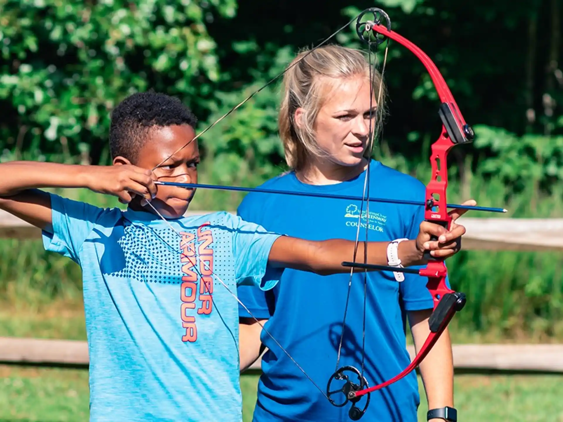 a man and a woman playing with a bow and arrow