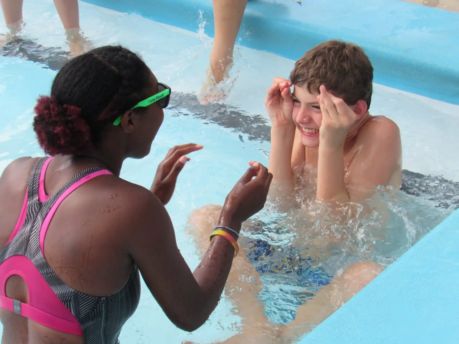 a person and a boy in a pool