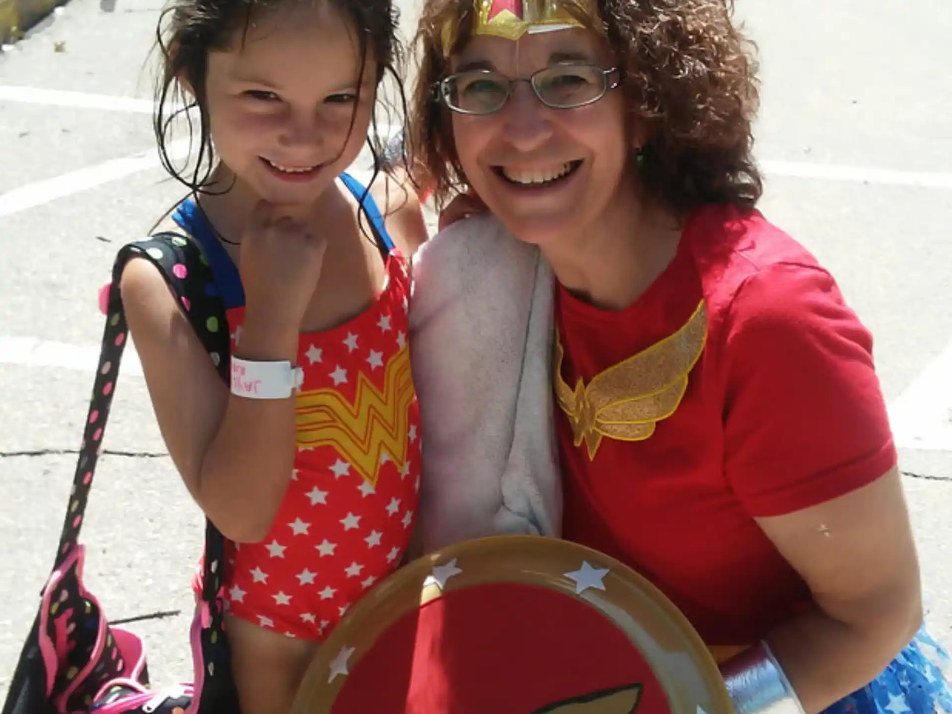 a person and a girl holding a drum