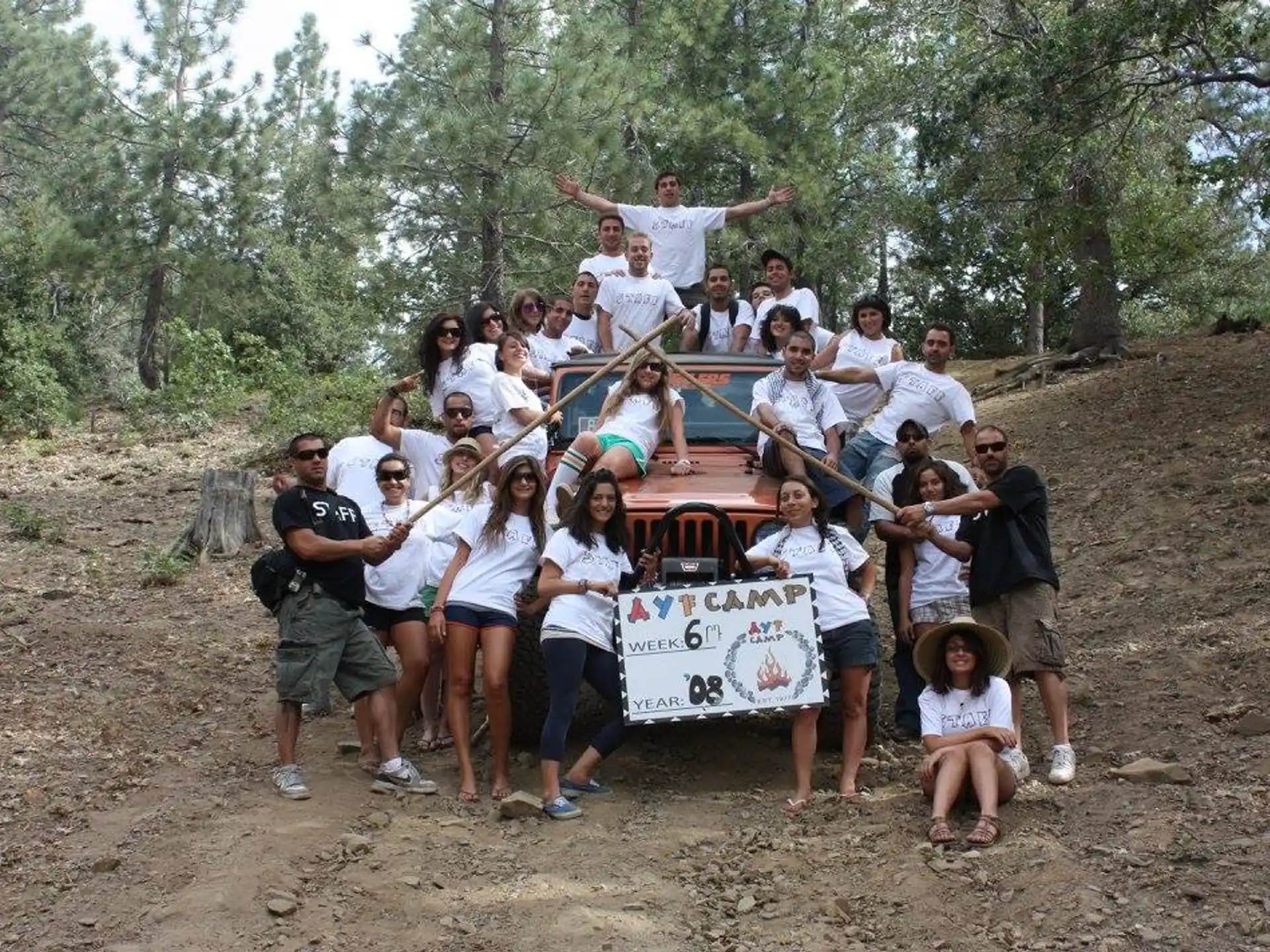 a group of people posing for a photo with a sign
