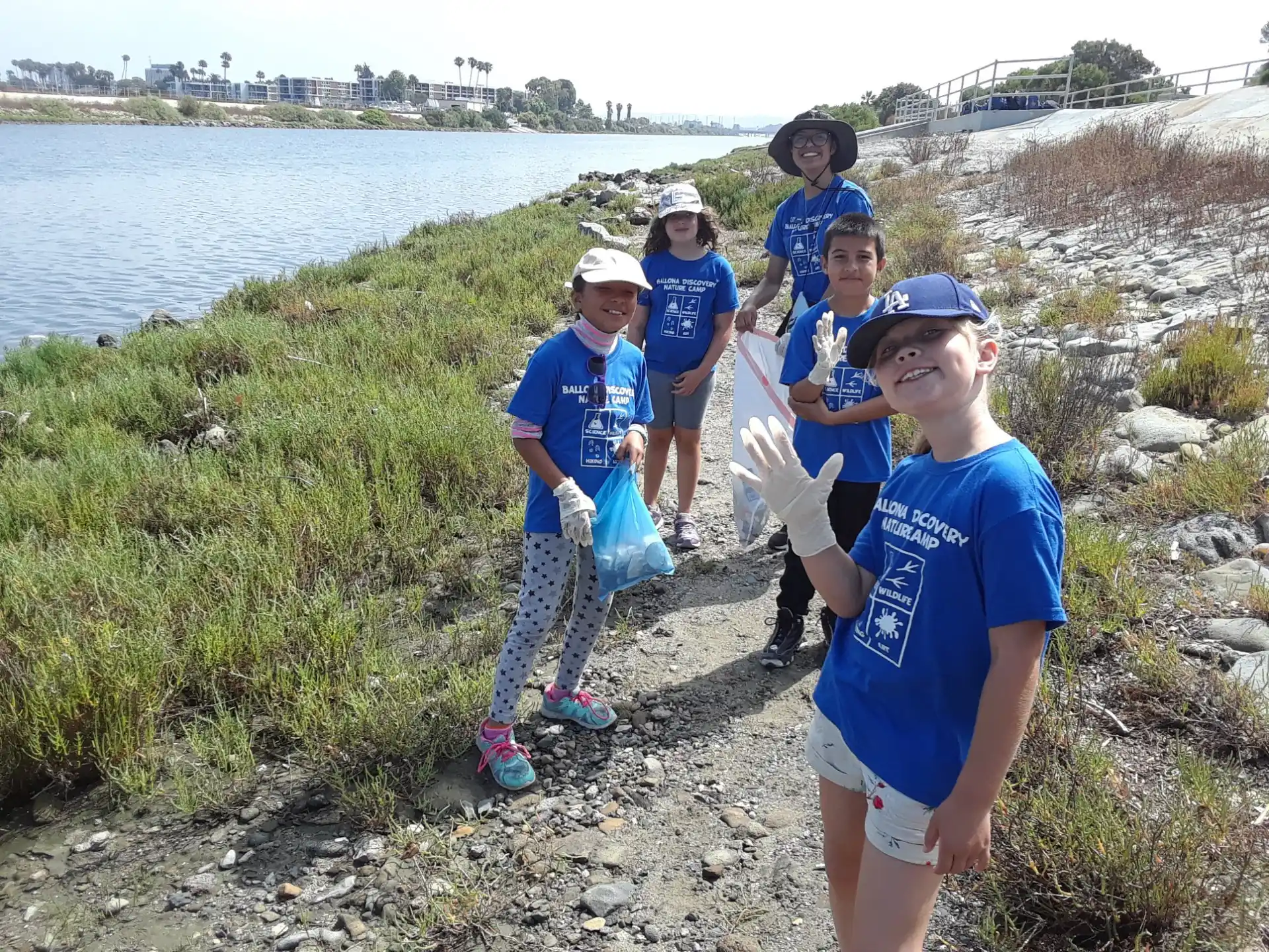 a group of kids standing on a rocky shore