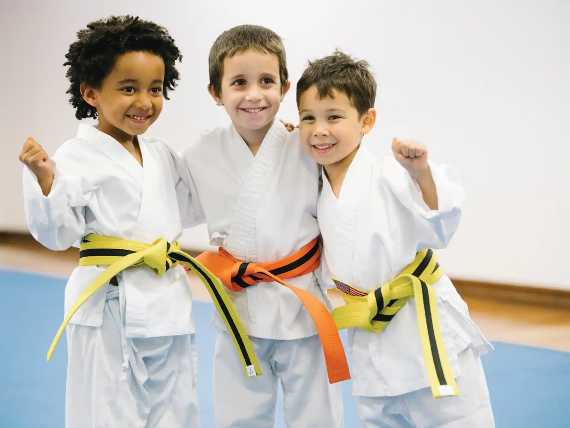 a group of kids in karate uniforms