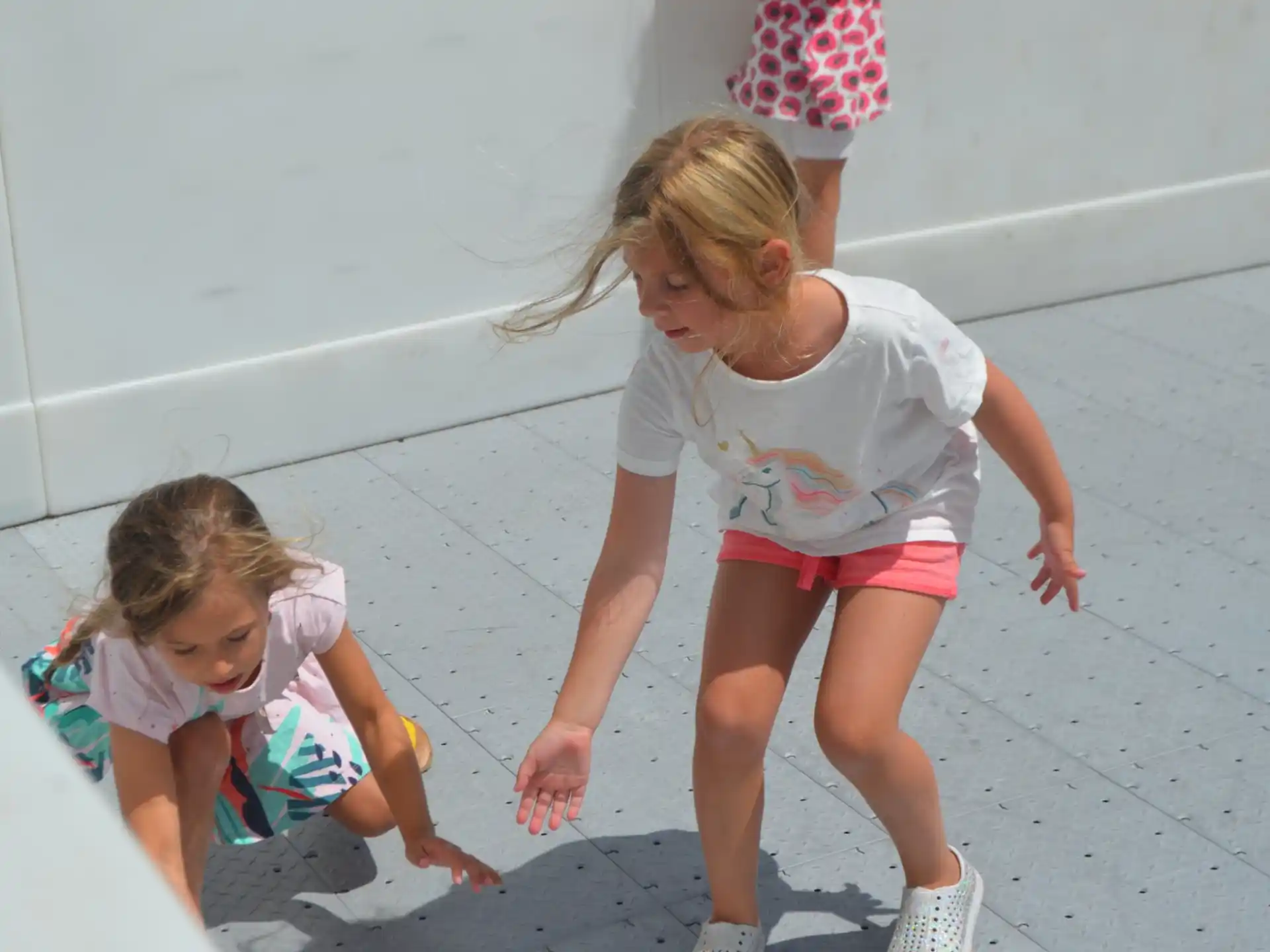 a girl and a girl playing in a pool