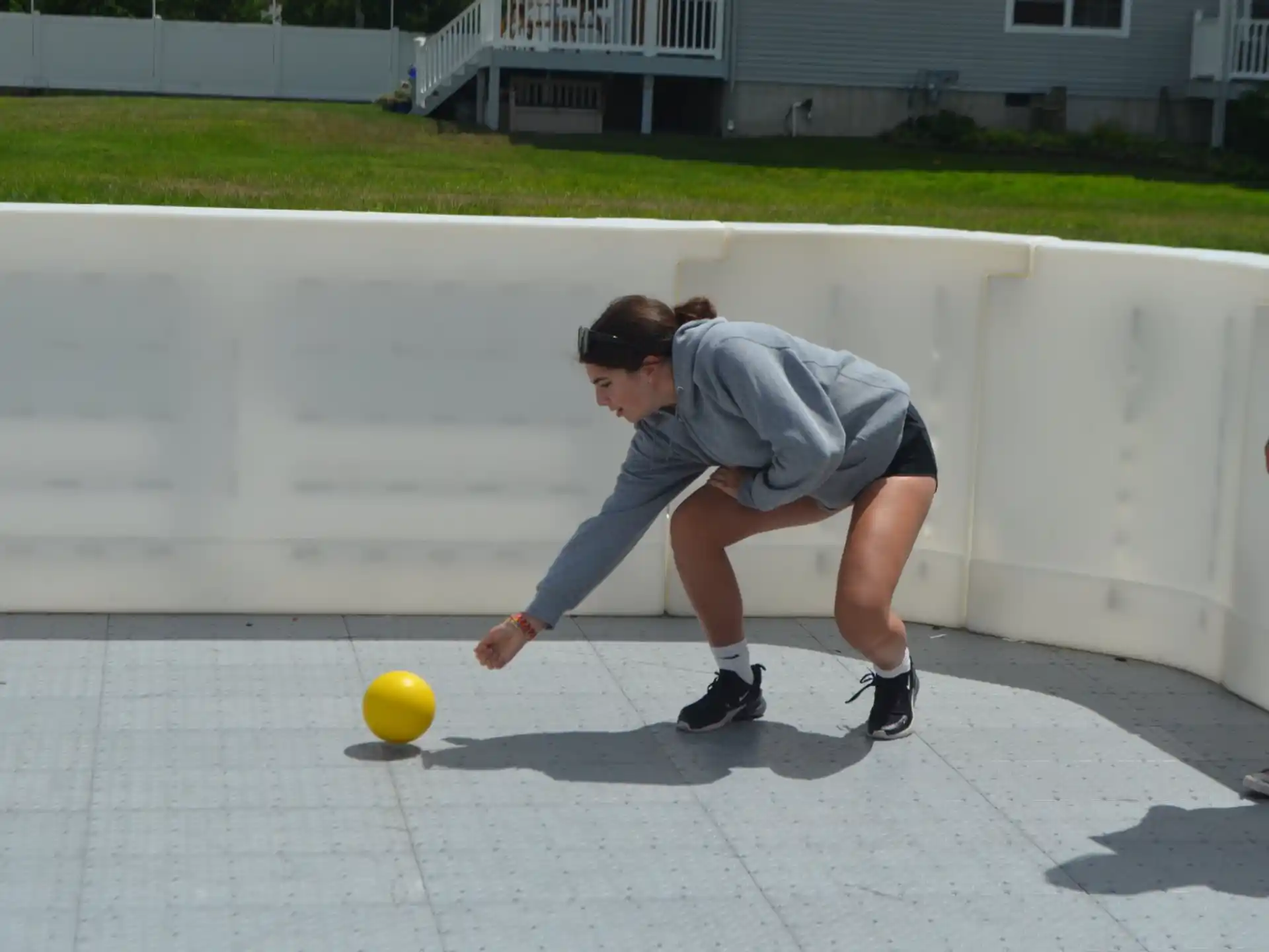 a man playing with a yellow ball