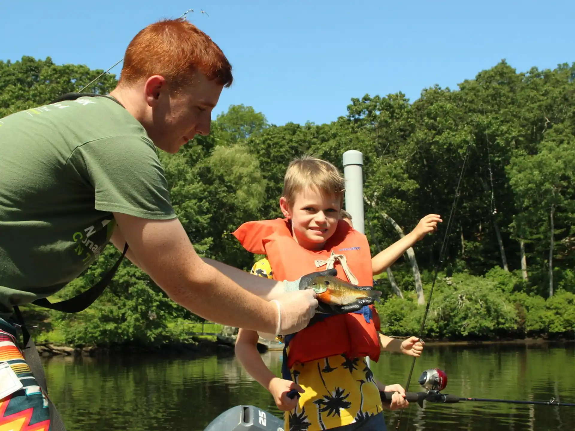 a man and a boy in a boat on a lake