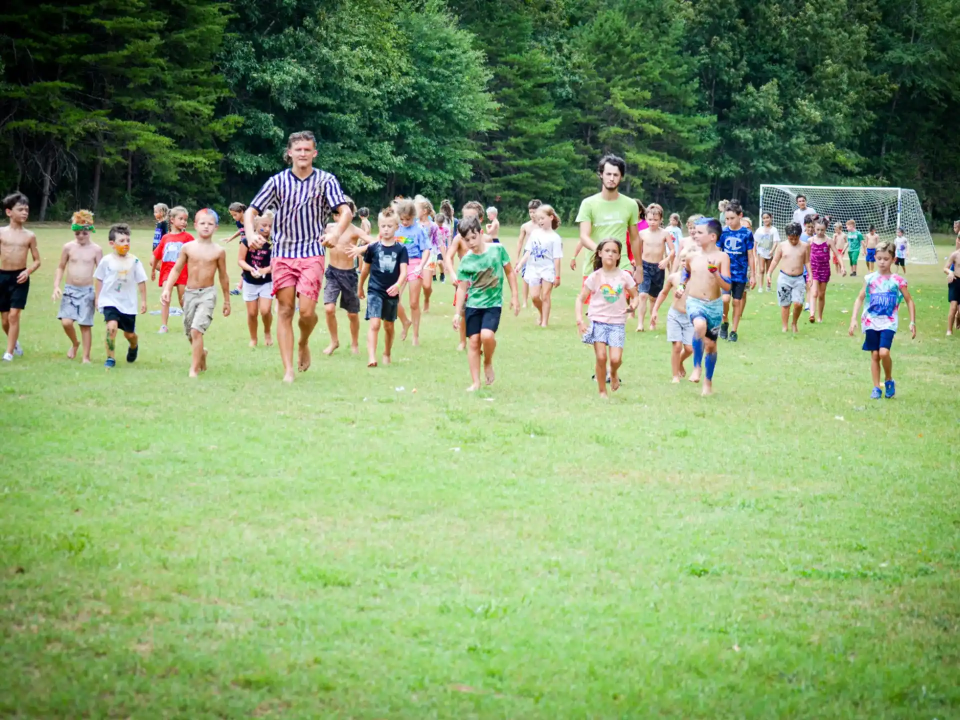 a group of people running on a field