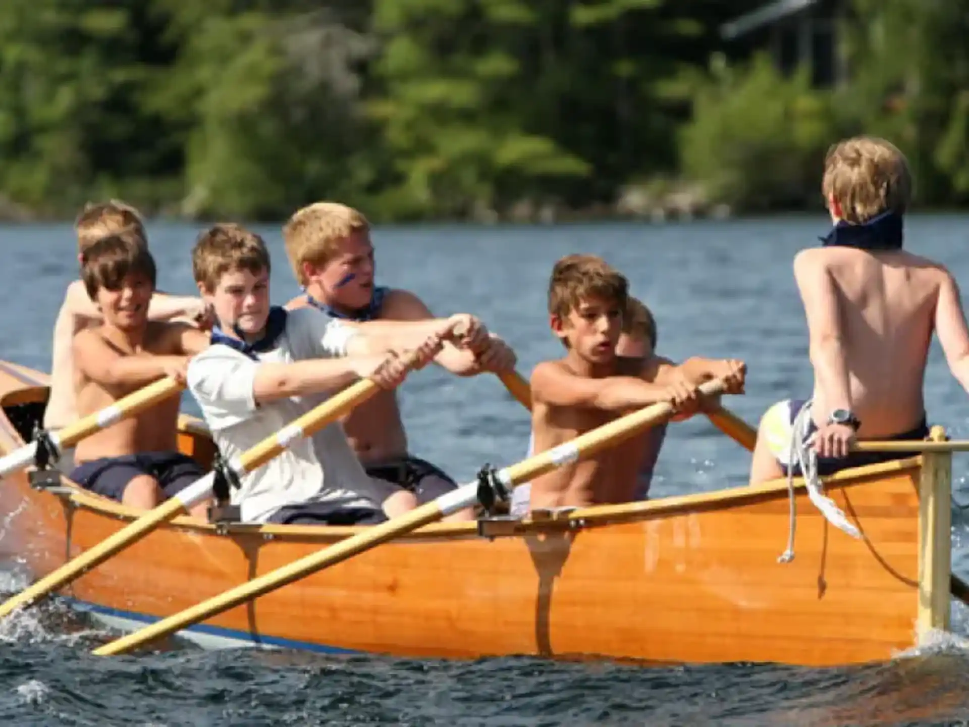 a group of boys in a canoe