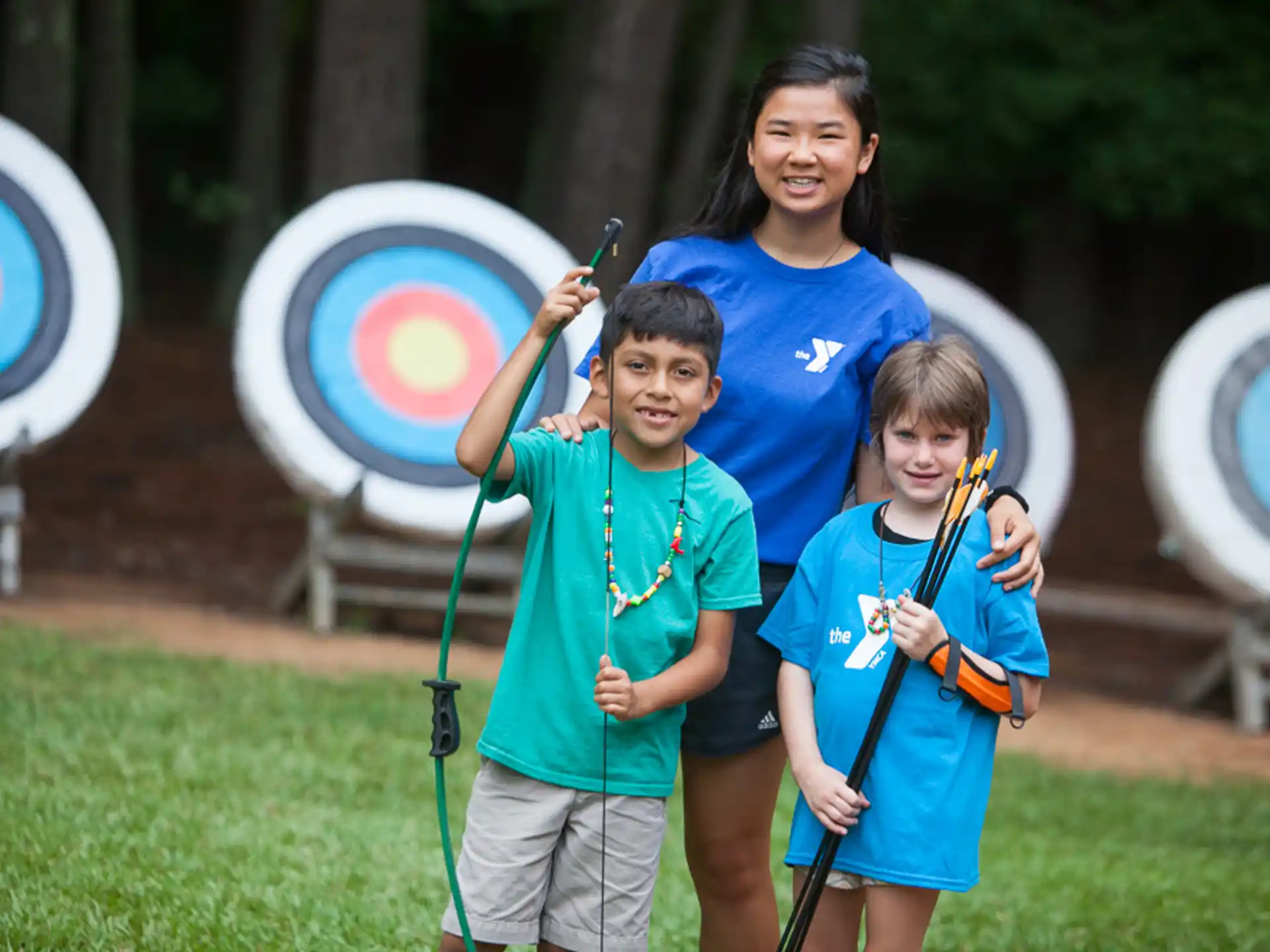 a group of kids holding bows and arrows