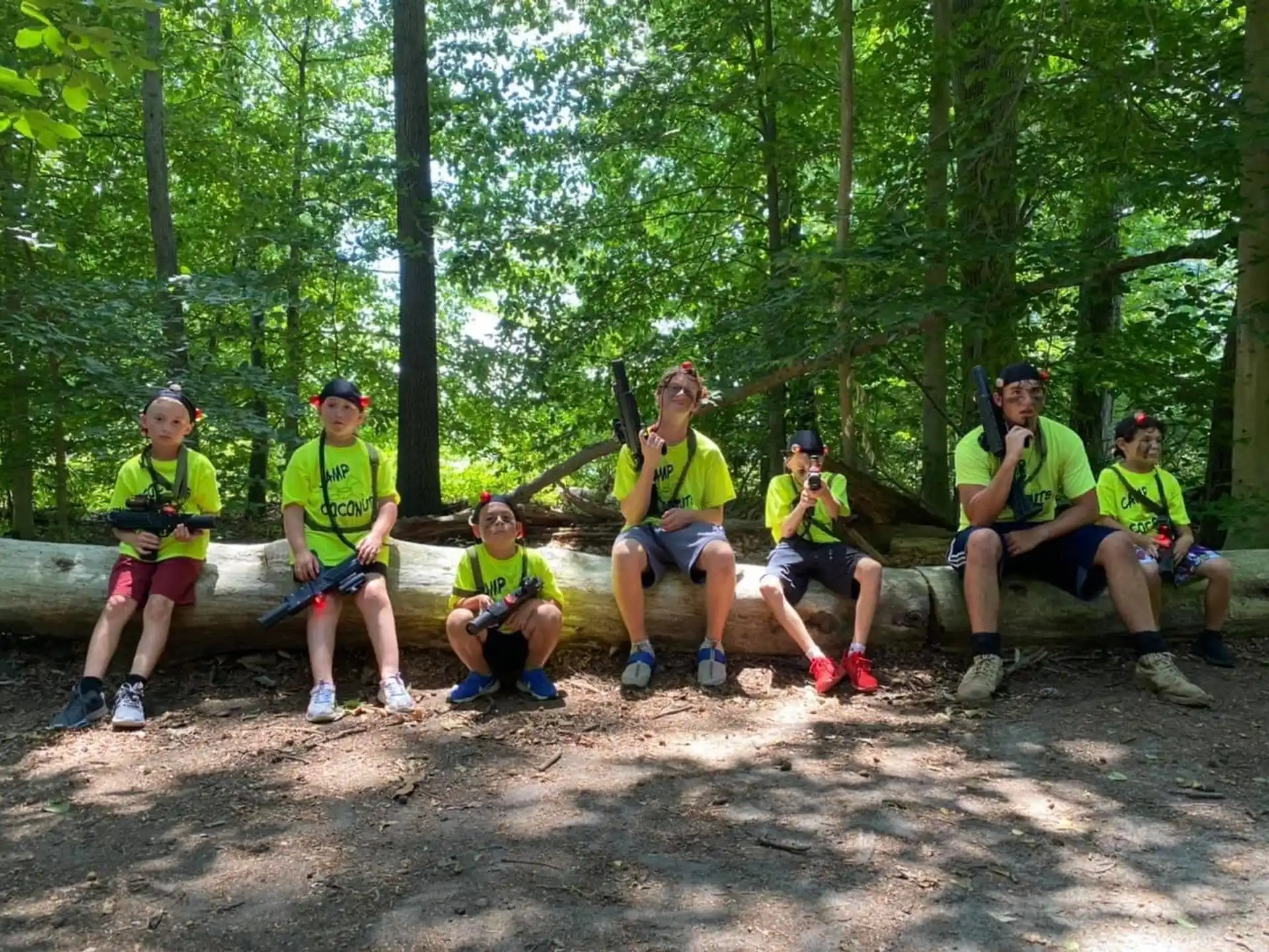 a group of people sitting on a bench in the woods