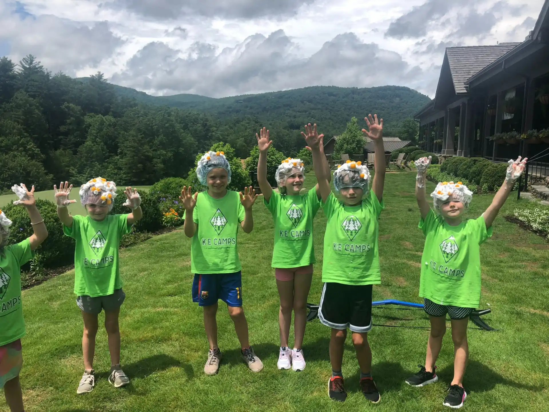a group of children in green shirts