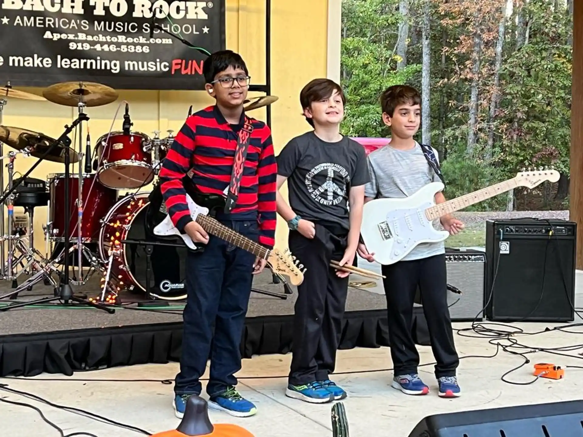 a group of people standing on a stage with instruments