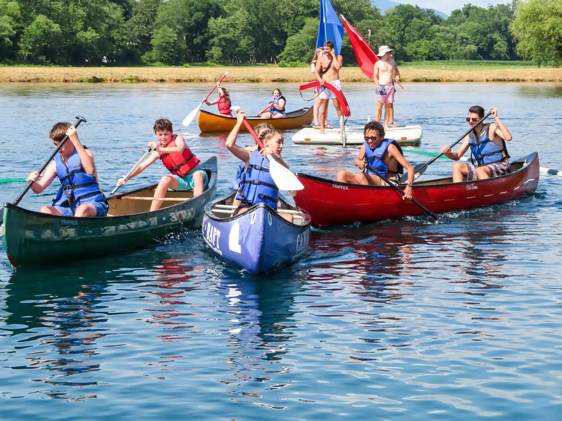 a group of people in canoes