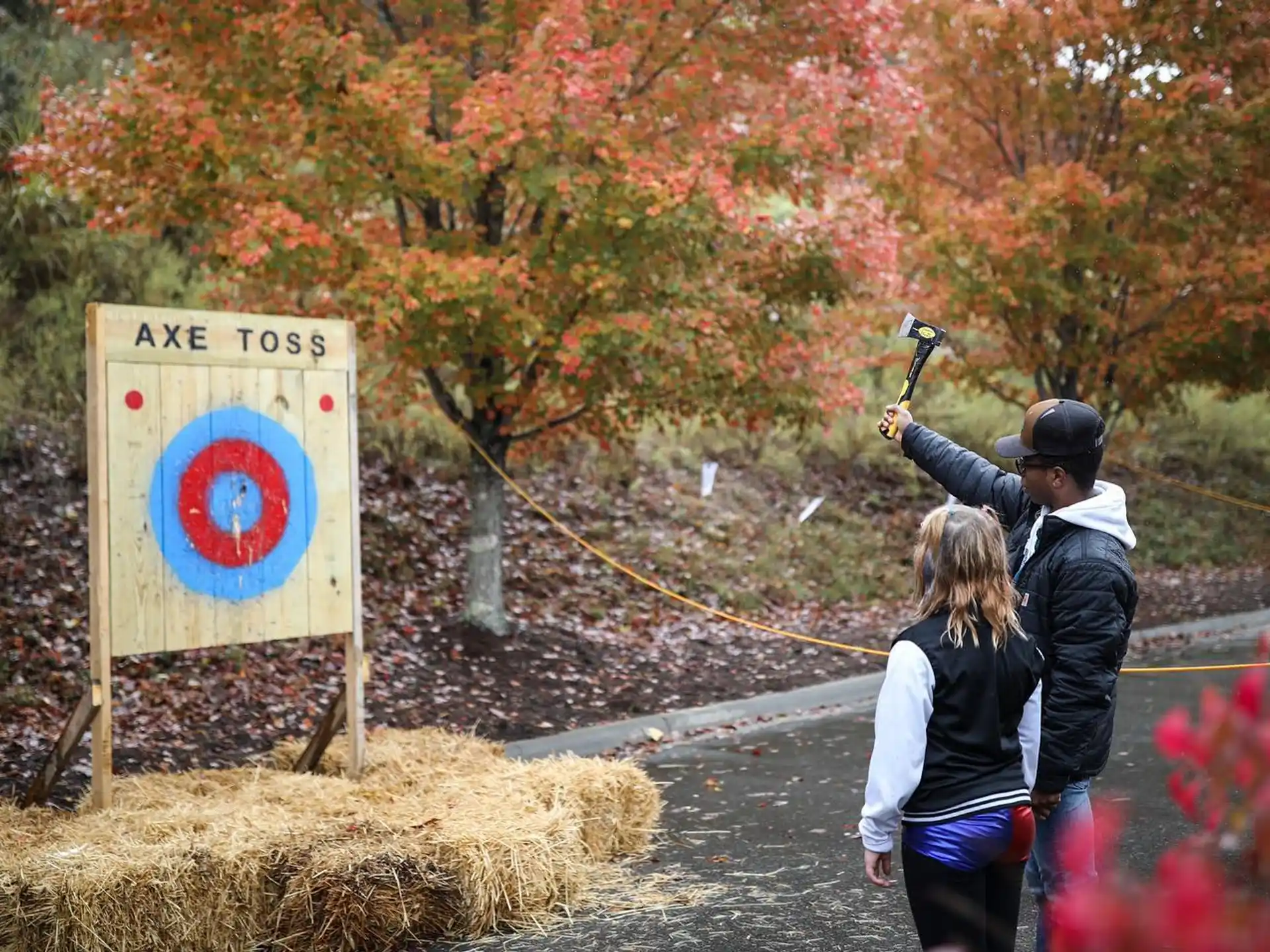 a man and woman shooting a bow and arrow at a target