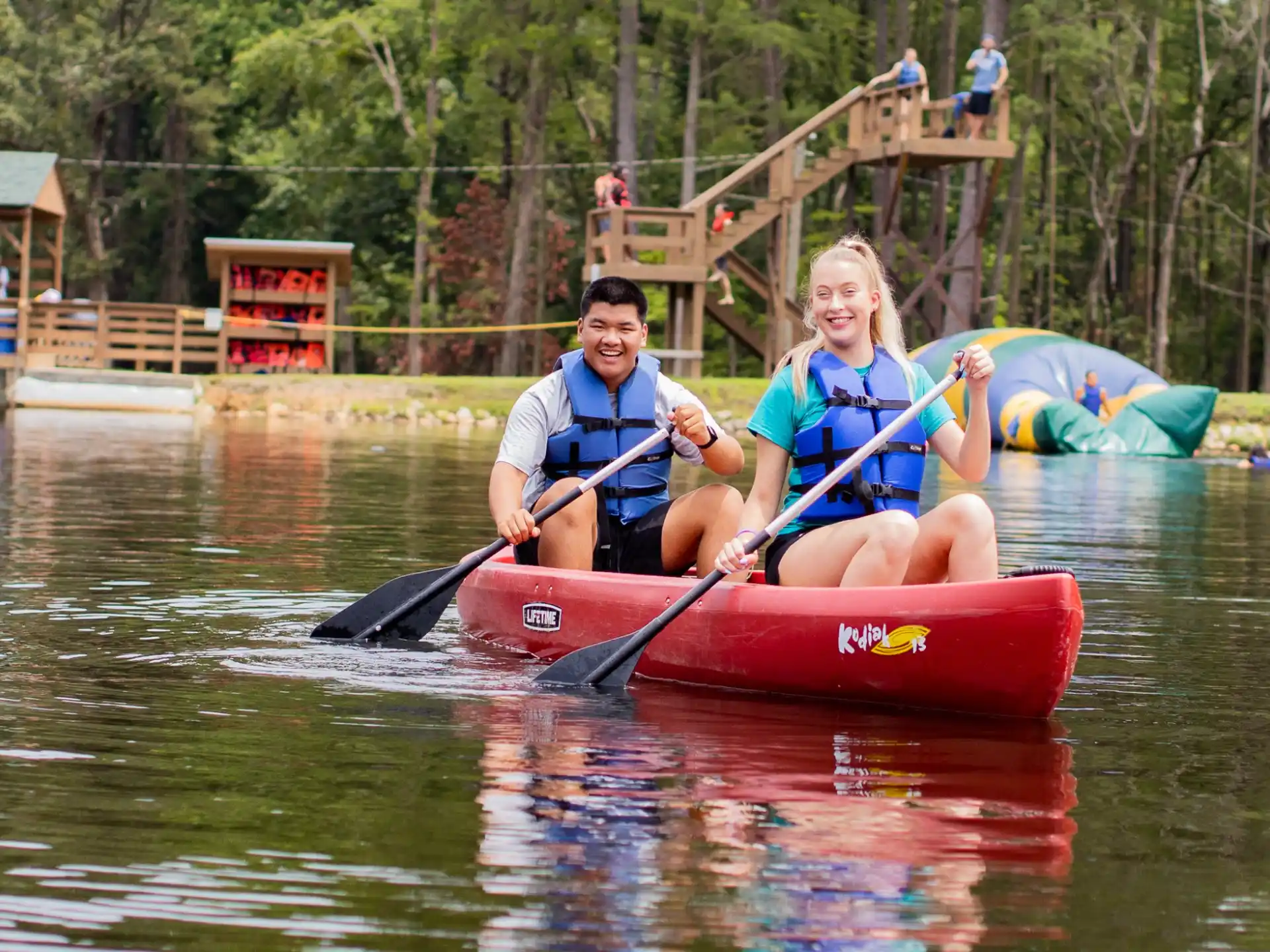 a man and a woman in a canoe on a river