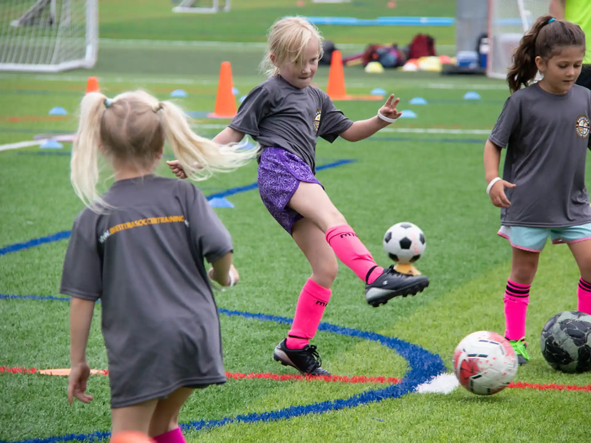 girls playing football on a field
