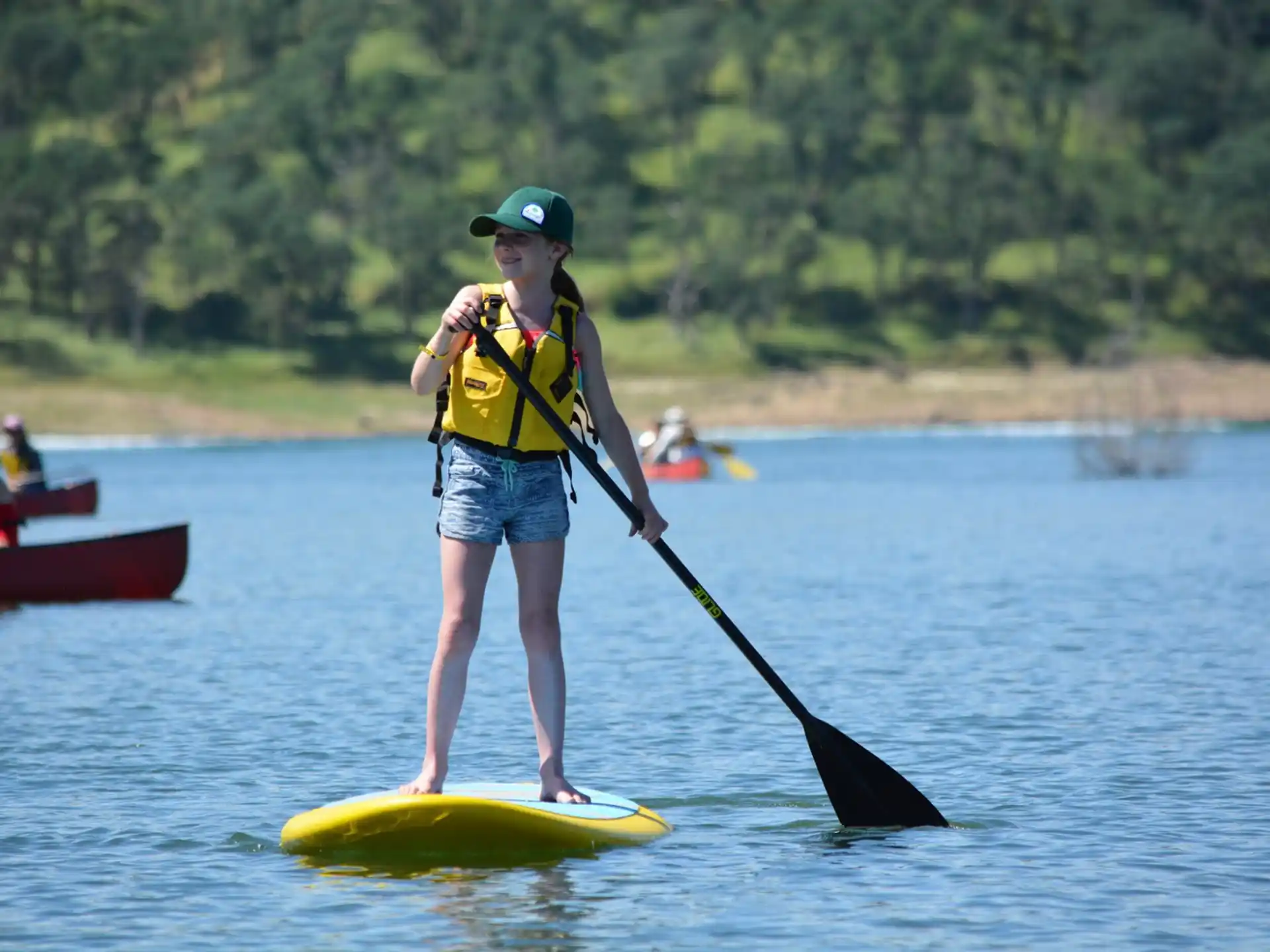 a boy on a paddle board