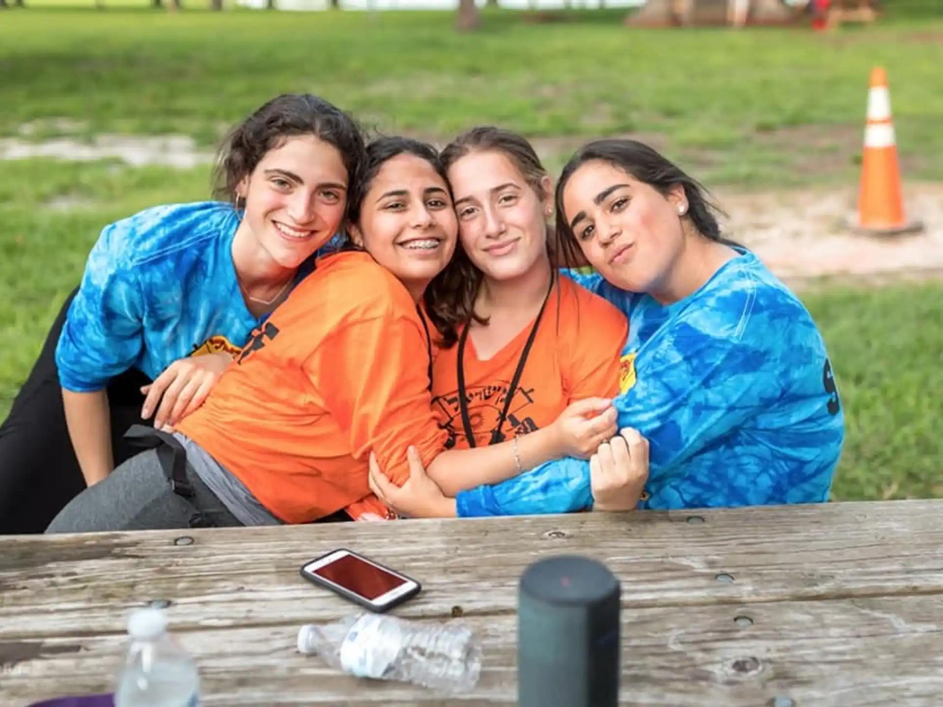 a group of women sitting at a table outside