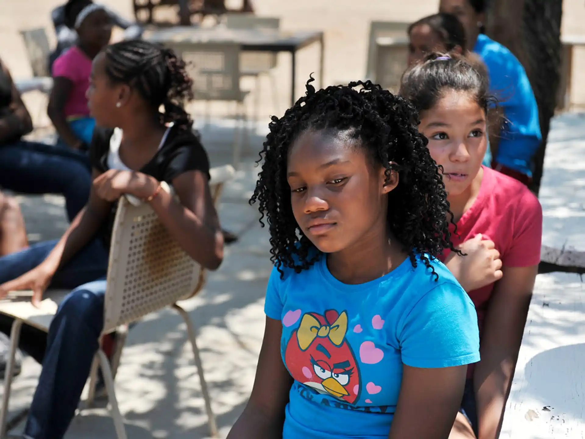 a group of children sitting in chairs