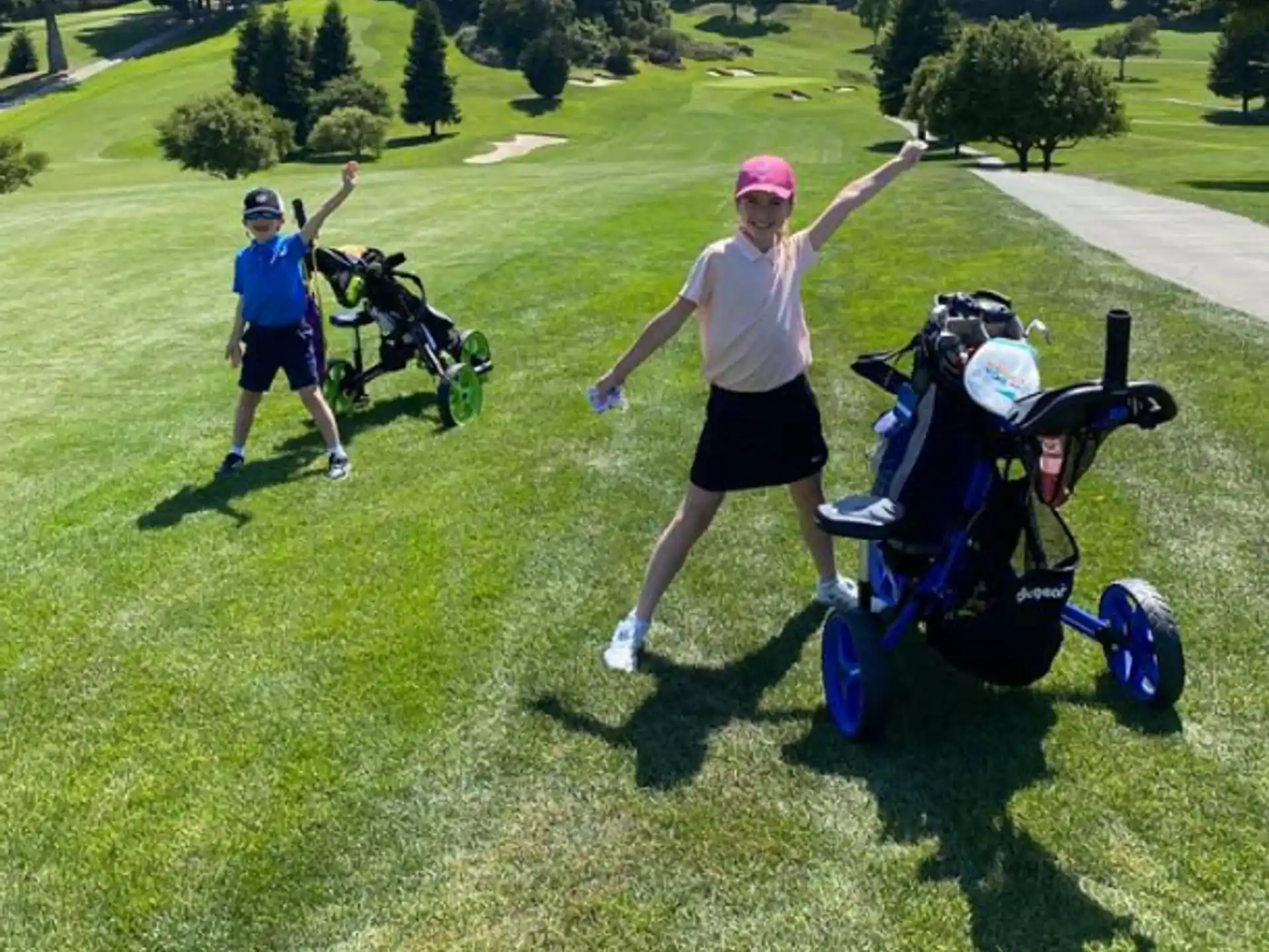 a person and two children on a golf course