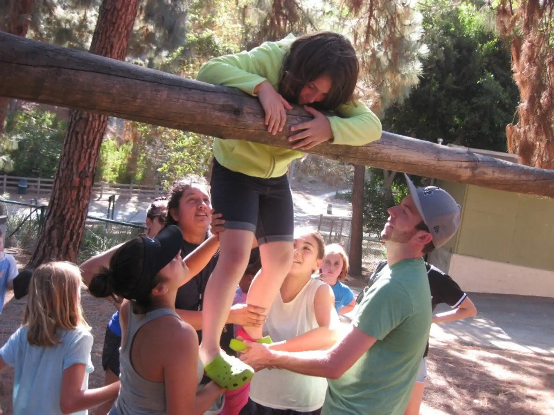 a group of people around a person who is holding a child