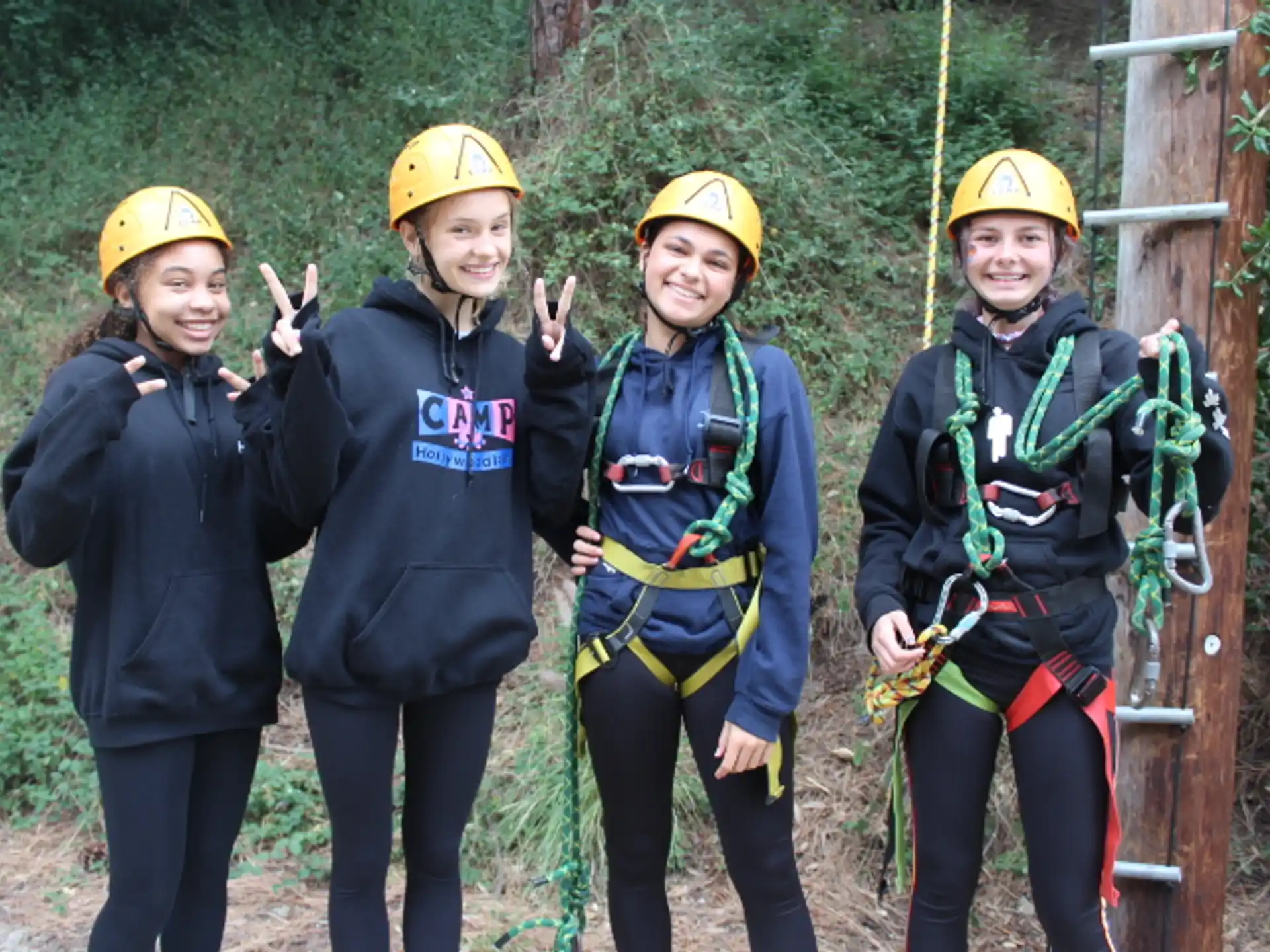 a group of people wearing helmets and harnesses