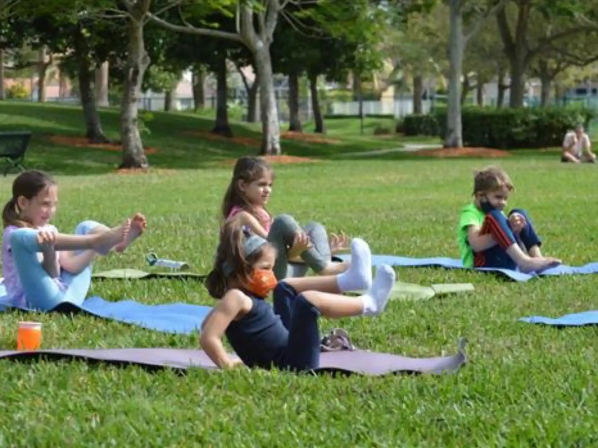 a group of children sitting on the grass