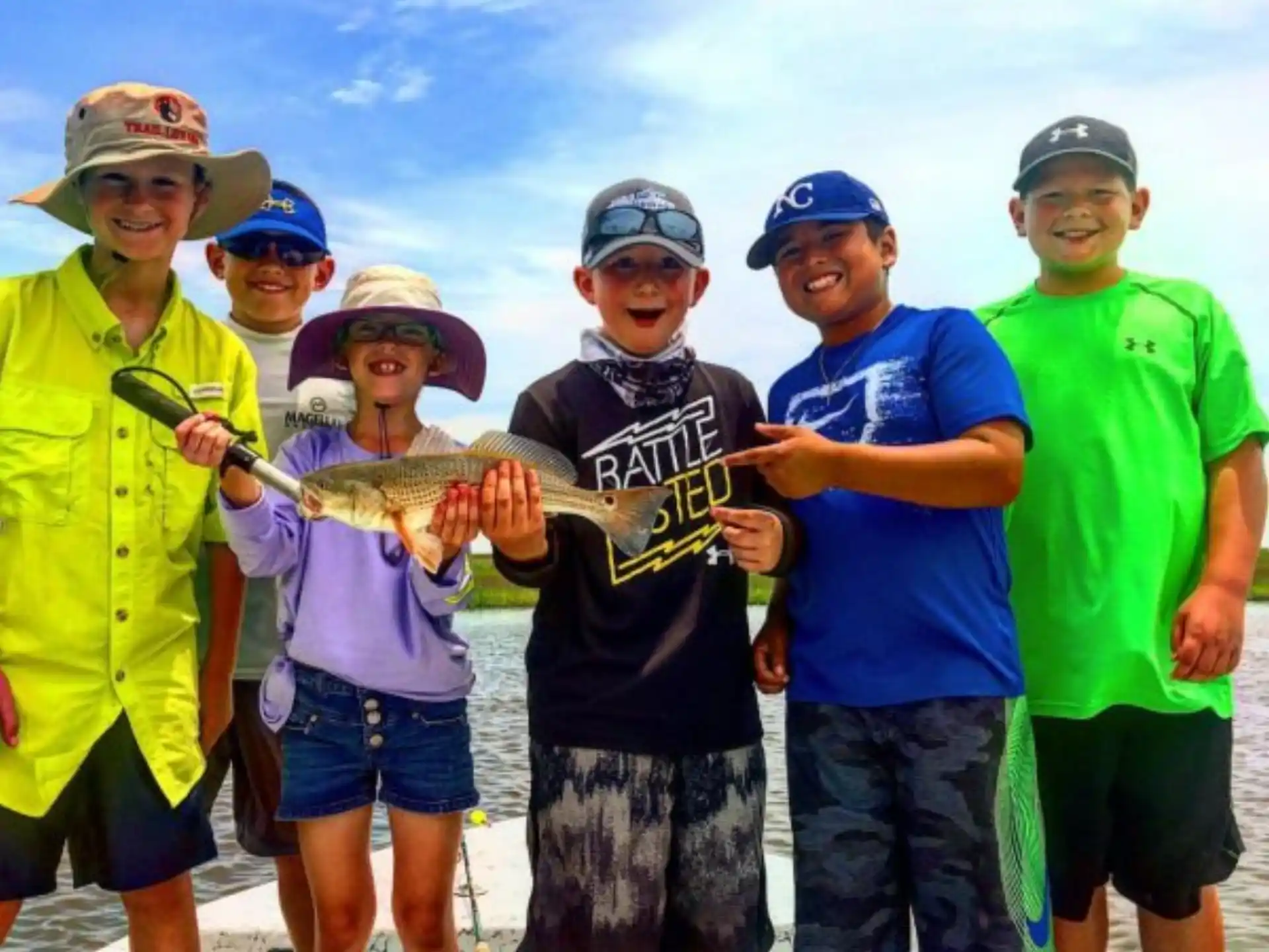 a group of people holding a fish