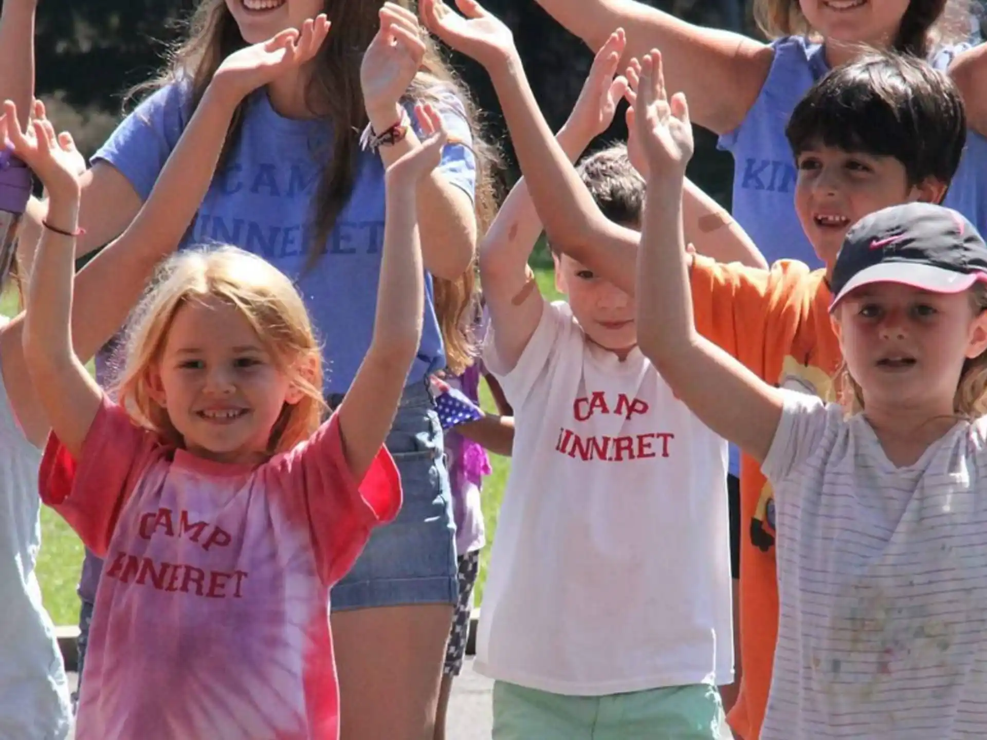 a group of children raising their hands