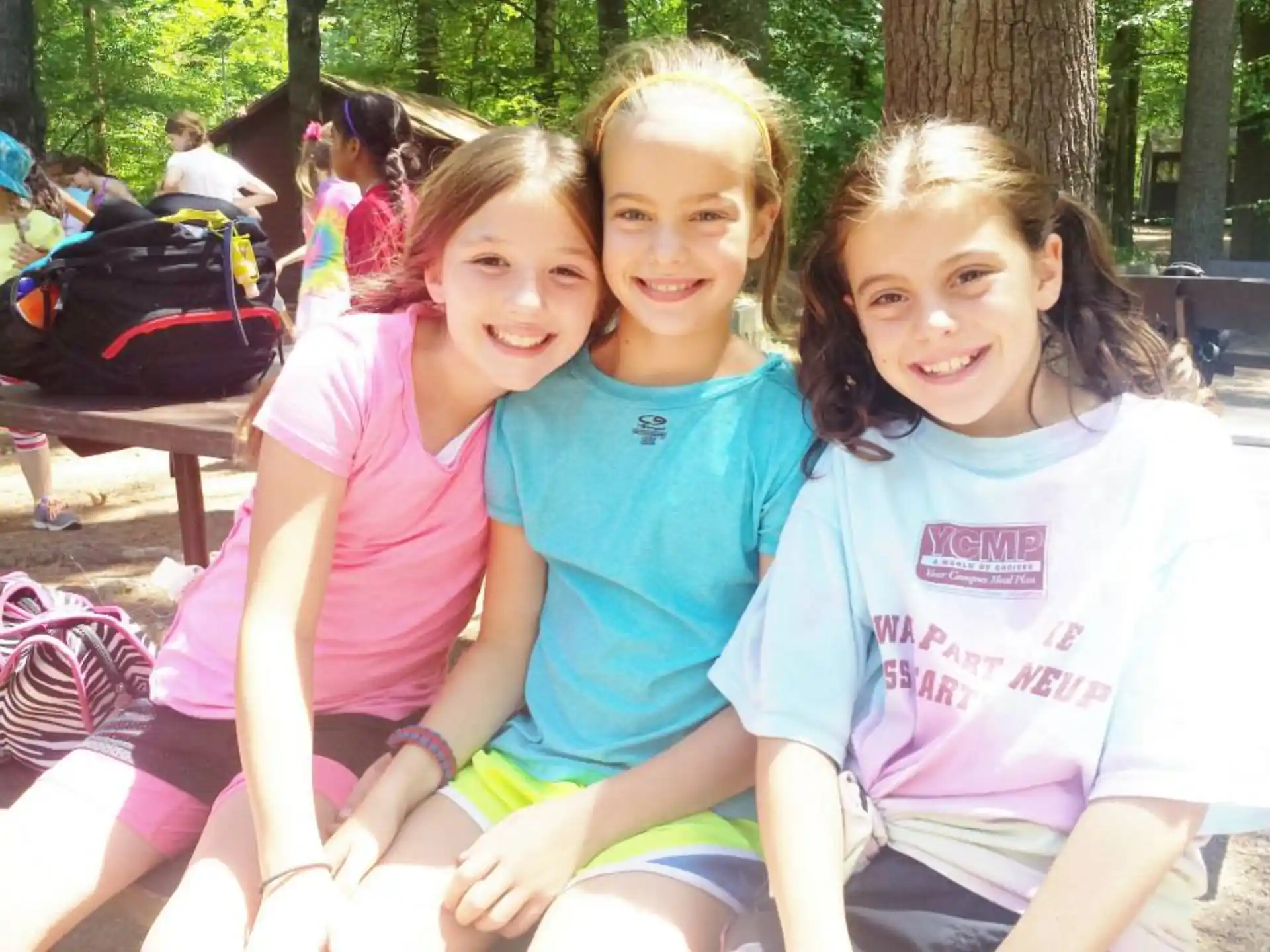 a group of girls sitting on a bench