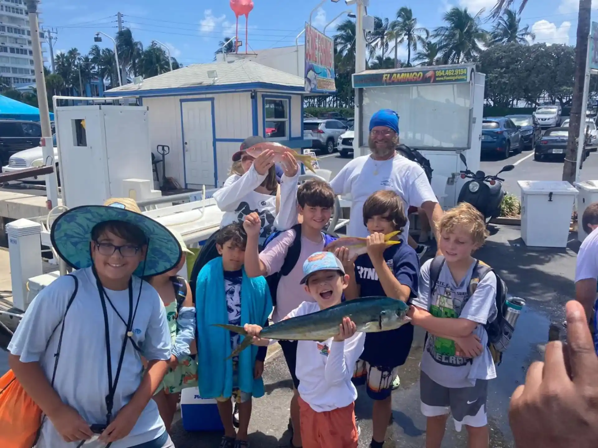 a group of people holding a fish