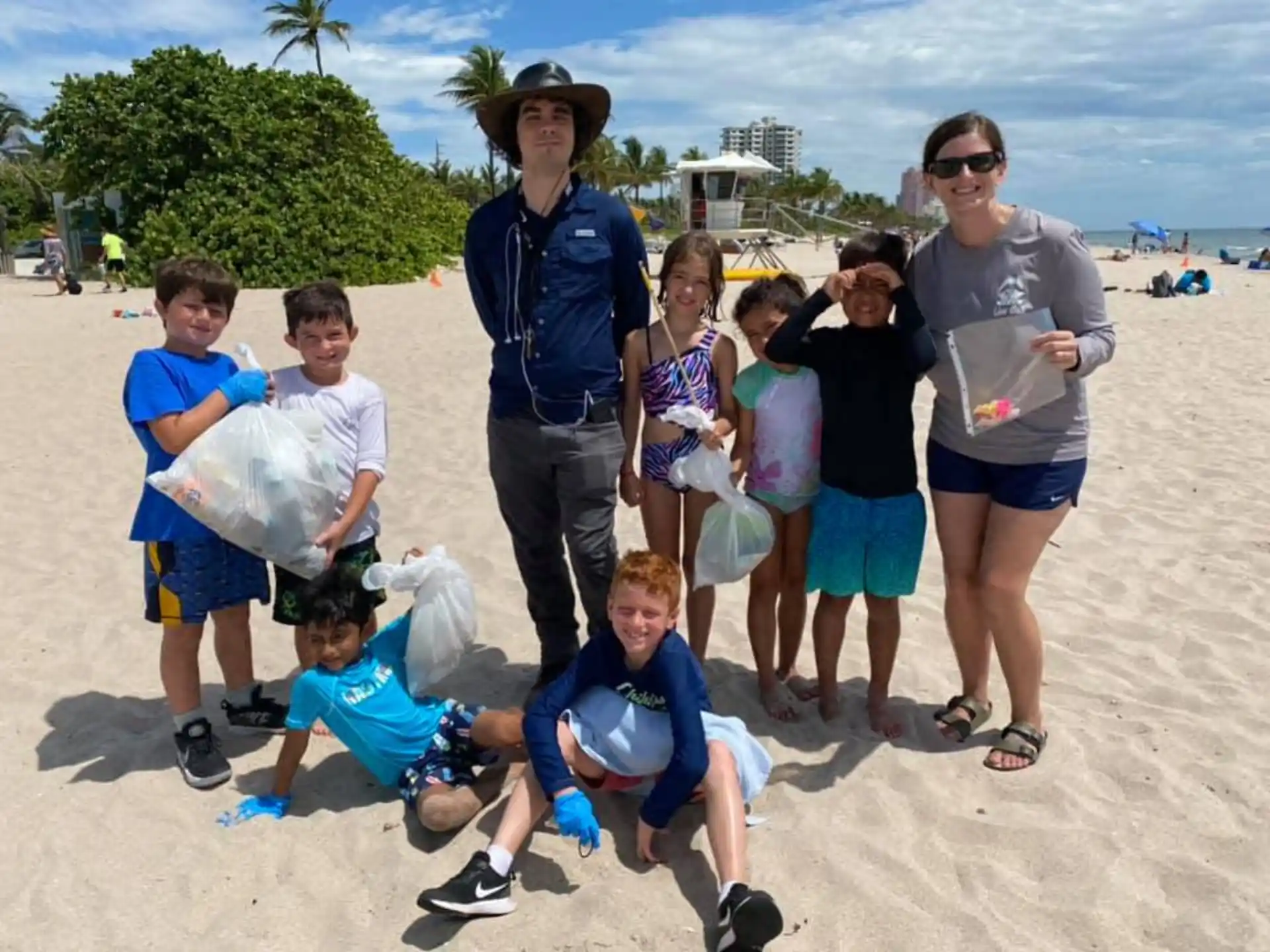 a group of people posing for a photo on a beach