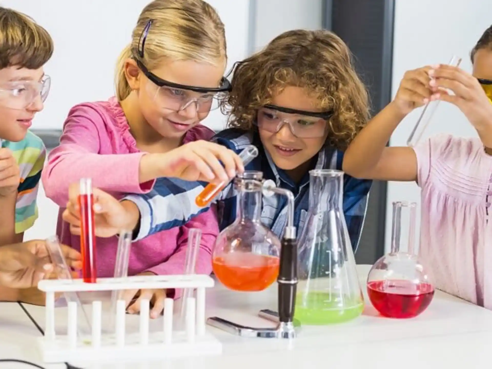 a group of kids looking at a microscope